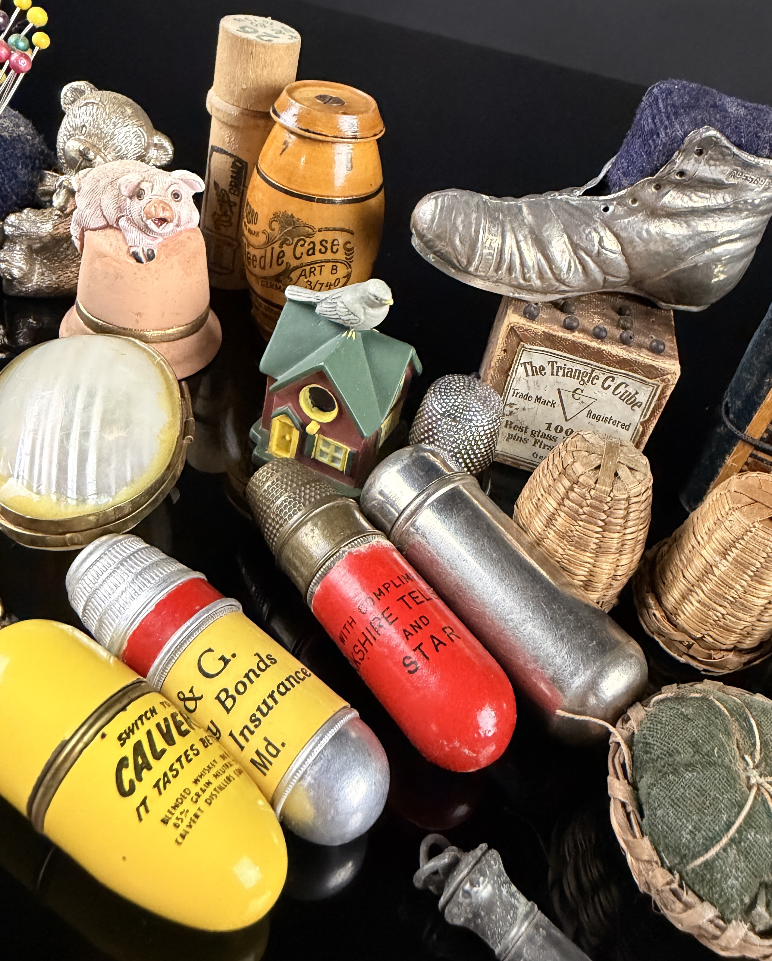 A Collection of Antique and Vintage Sewing Novelties, Tools, and Advertising Cases