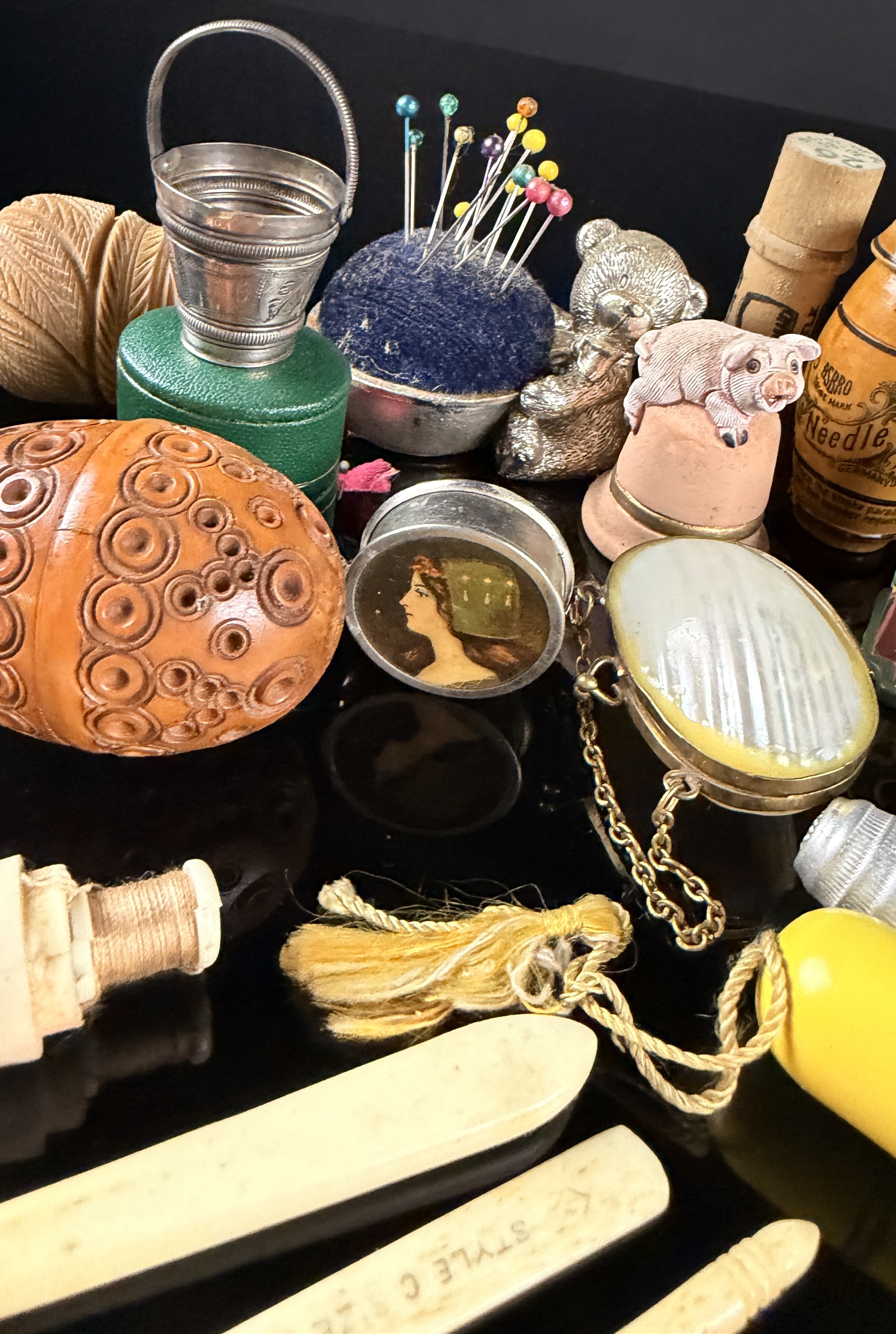 A Collection of Antique and Vintage Sewing Novelties, Tools, and Advertising Cases