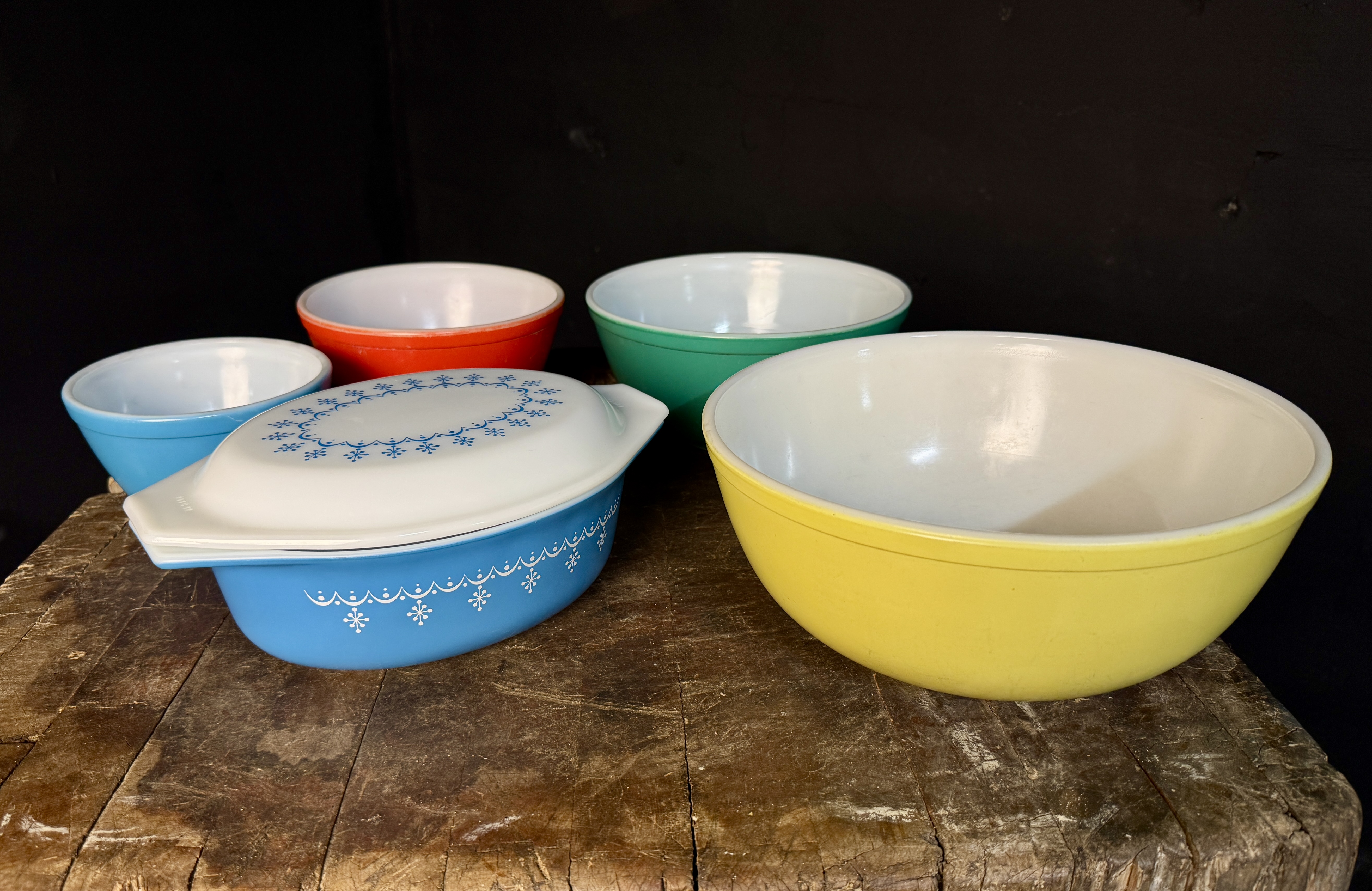 A Collection of Vintage Pyrex and Fire-King Primary Colors, Snowflake Garland, and Tulip Pattern Ovenware