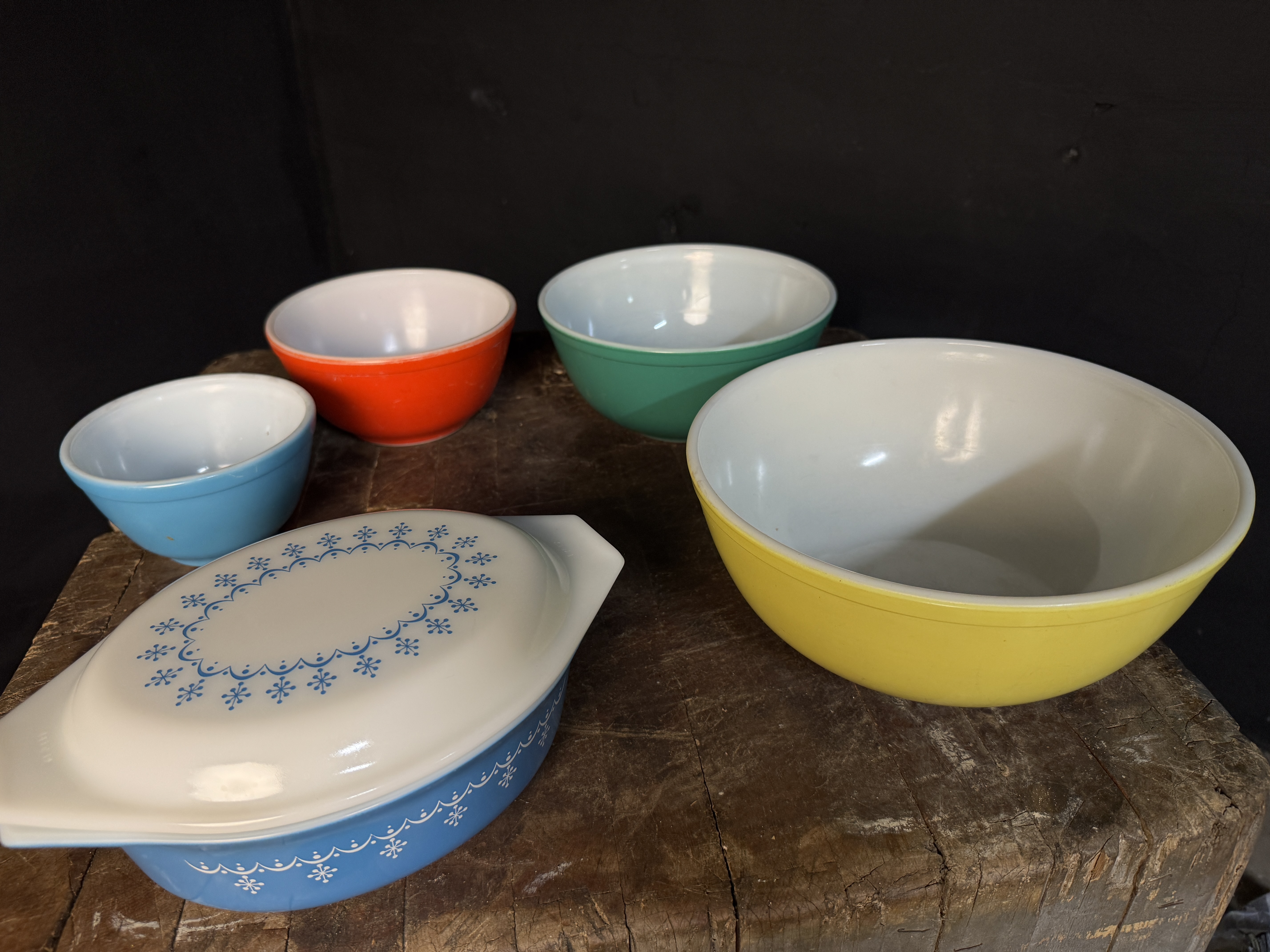A Collection of Vintage Pyrex and Fire-King Primary Colors, Snowflake Garland, and Tulip Pattern Ovenware