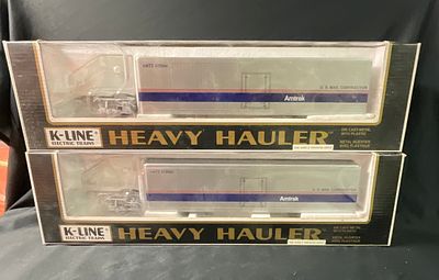 A Pair of K-Line Heavy Hauler Amtrak Model Tractor-Trailers in Original Boxes. This lot features 