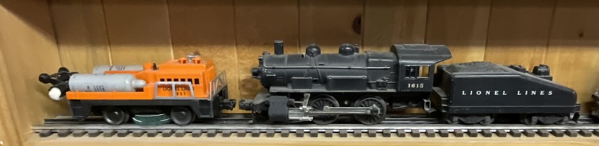 Three Lionel O-Gauge Model Train Pieces including 3927 Track Cleaning Car and 1615 Steam Locomotive with Tender