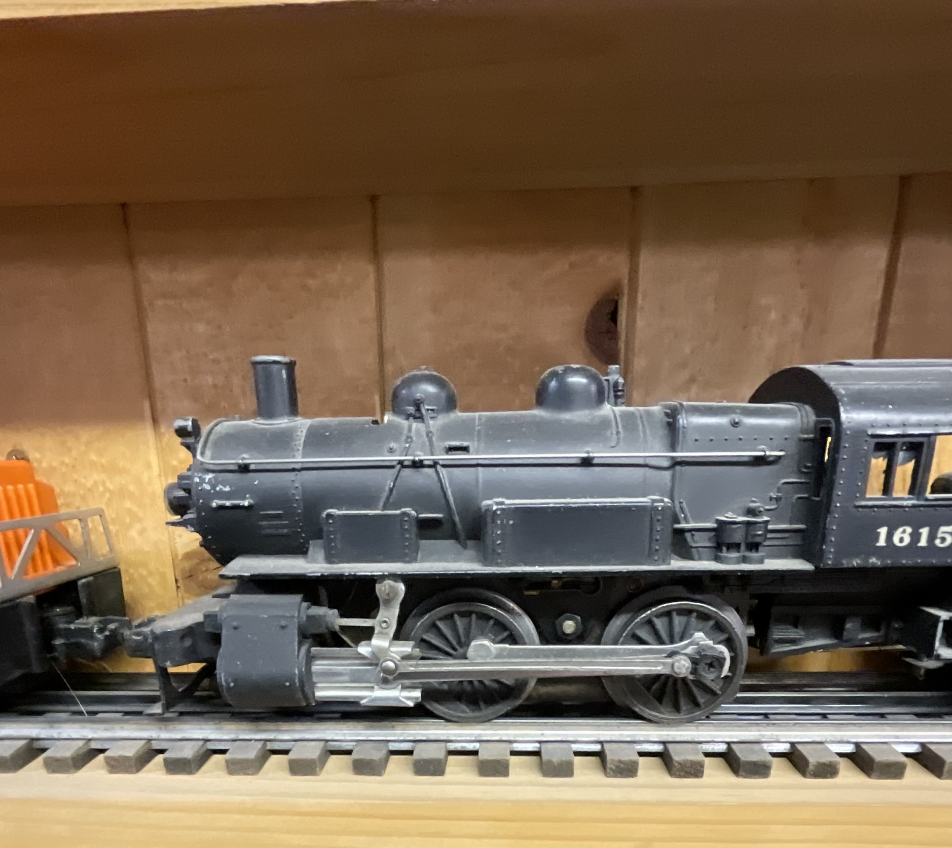 Three Lionel O-Gauge Model Train Pieces including 3927 Track Cleaning Car and 1615 Steam Locomotive with Tender
