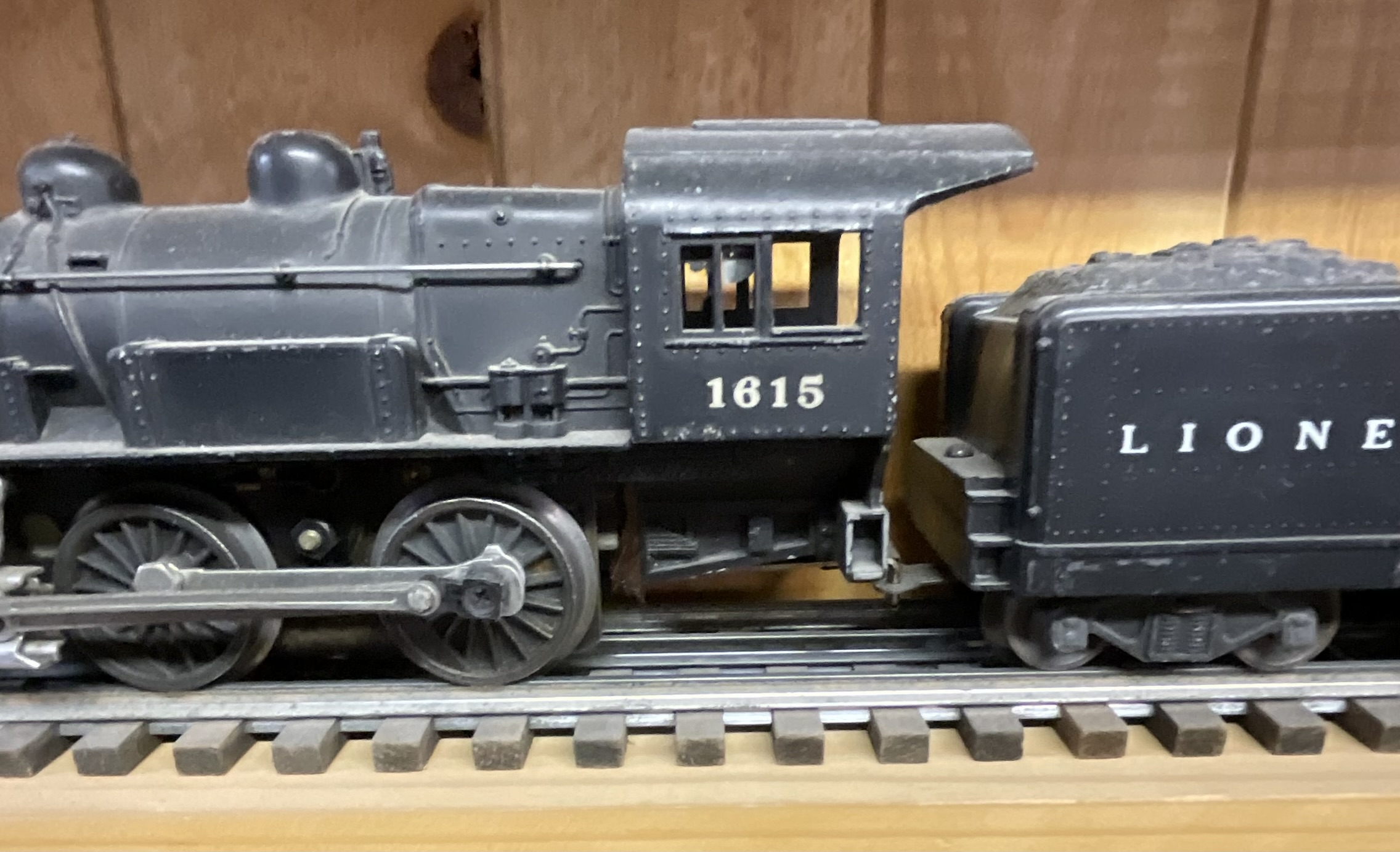 Three Lionel O-Gauge Model Train Pieces including 3927 Track Cleaning Car and 1615 Steam Locomotive with Tender