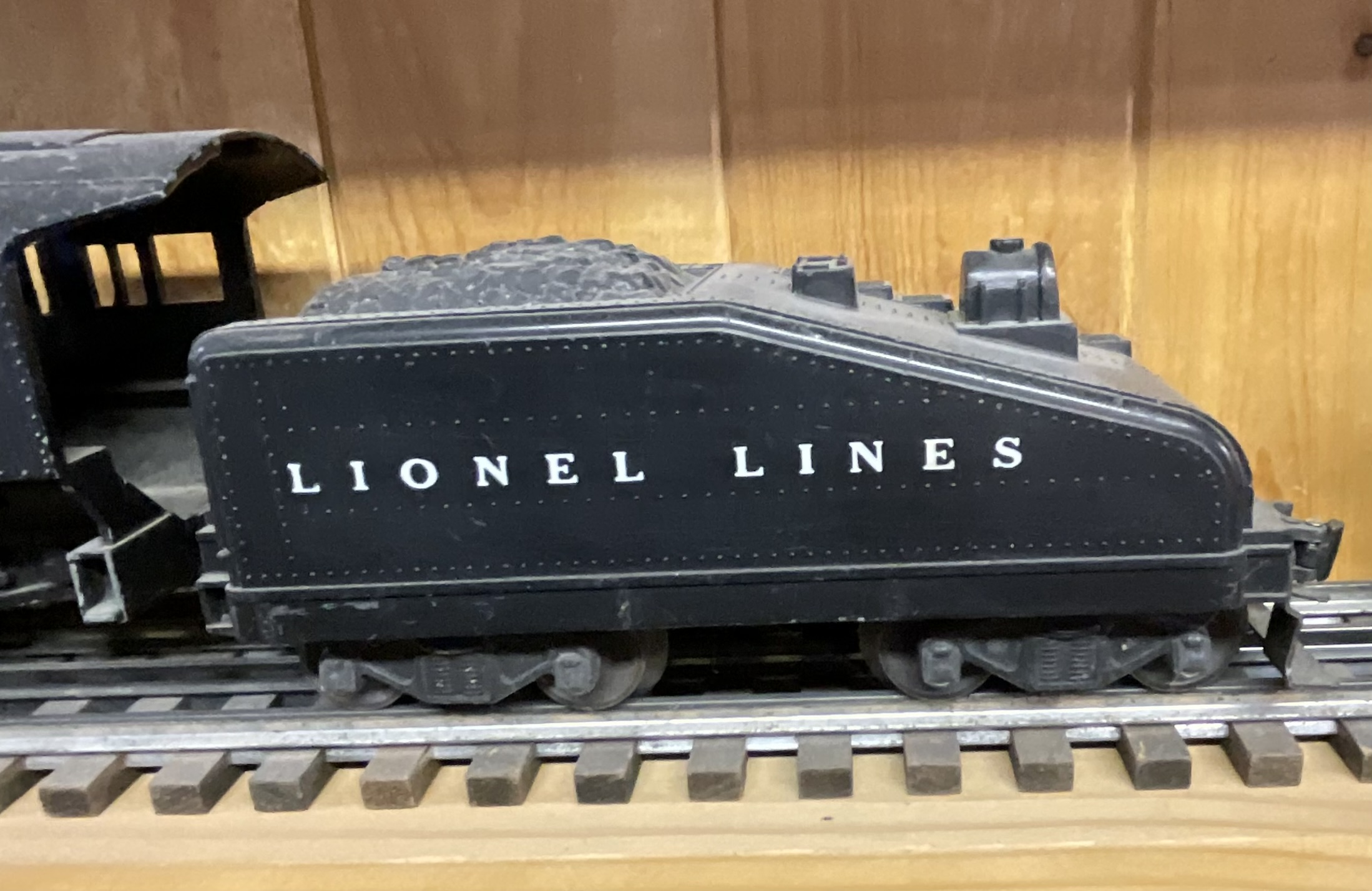 Three Lionel O-Gauge Model Train Pieces including 3927 Track Cleaning Car and 1615 Steam Locomotive with Tender
