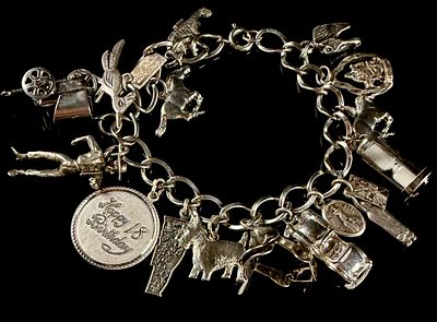Vintage Sterling Silver Curb Link Bracelet with 18 Assorted Charms. This vintage sterling silver 