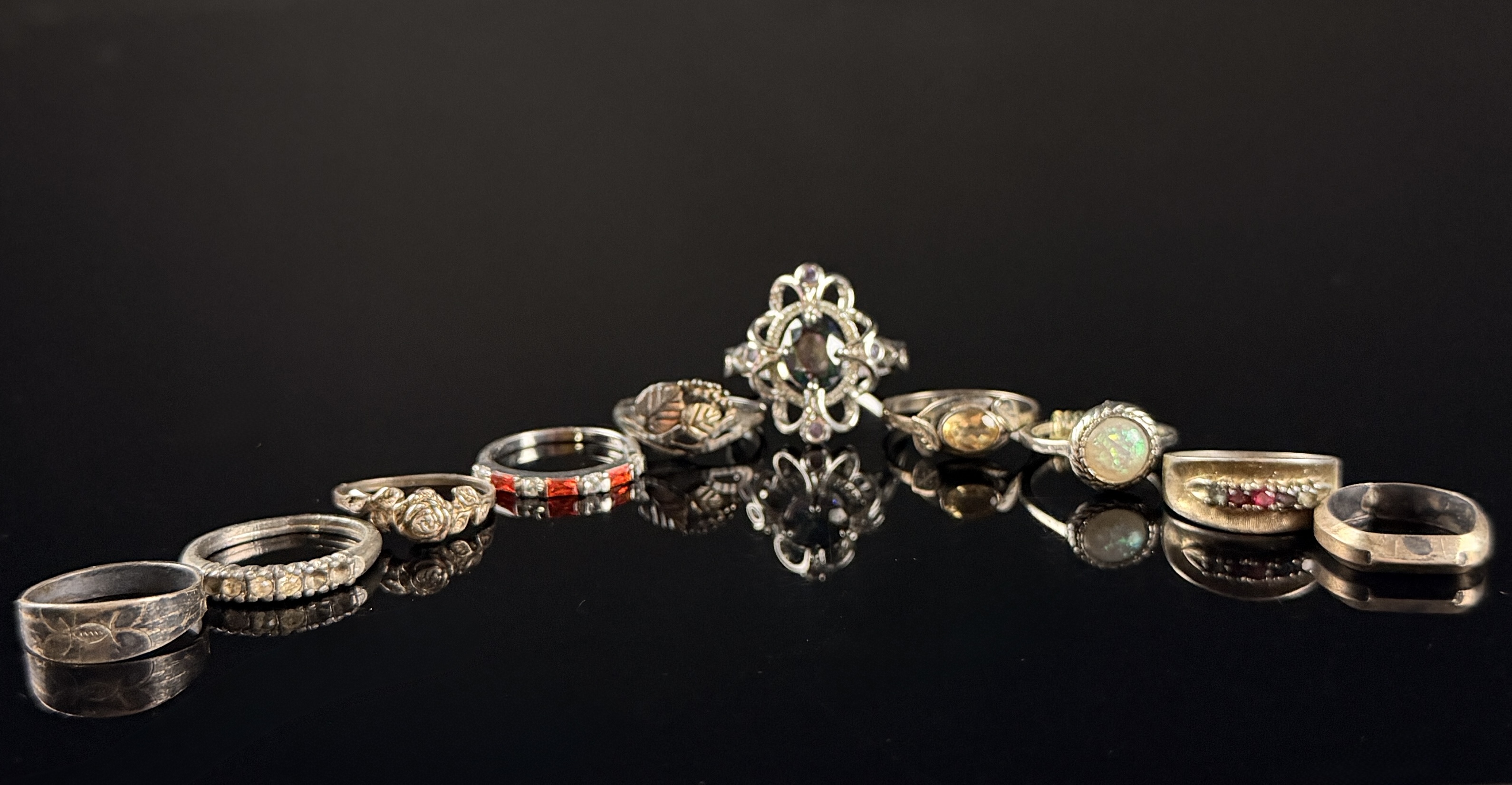 A Collection of Nine Sterling Silver Rings with Various Gemstones and Decorative Accents