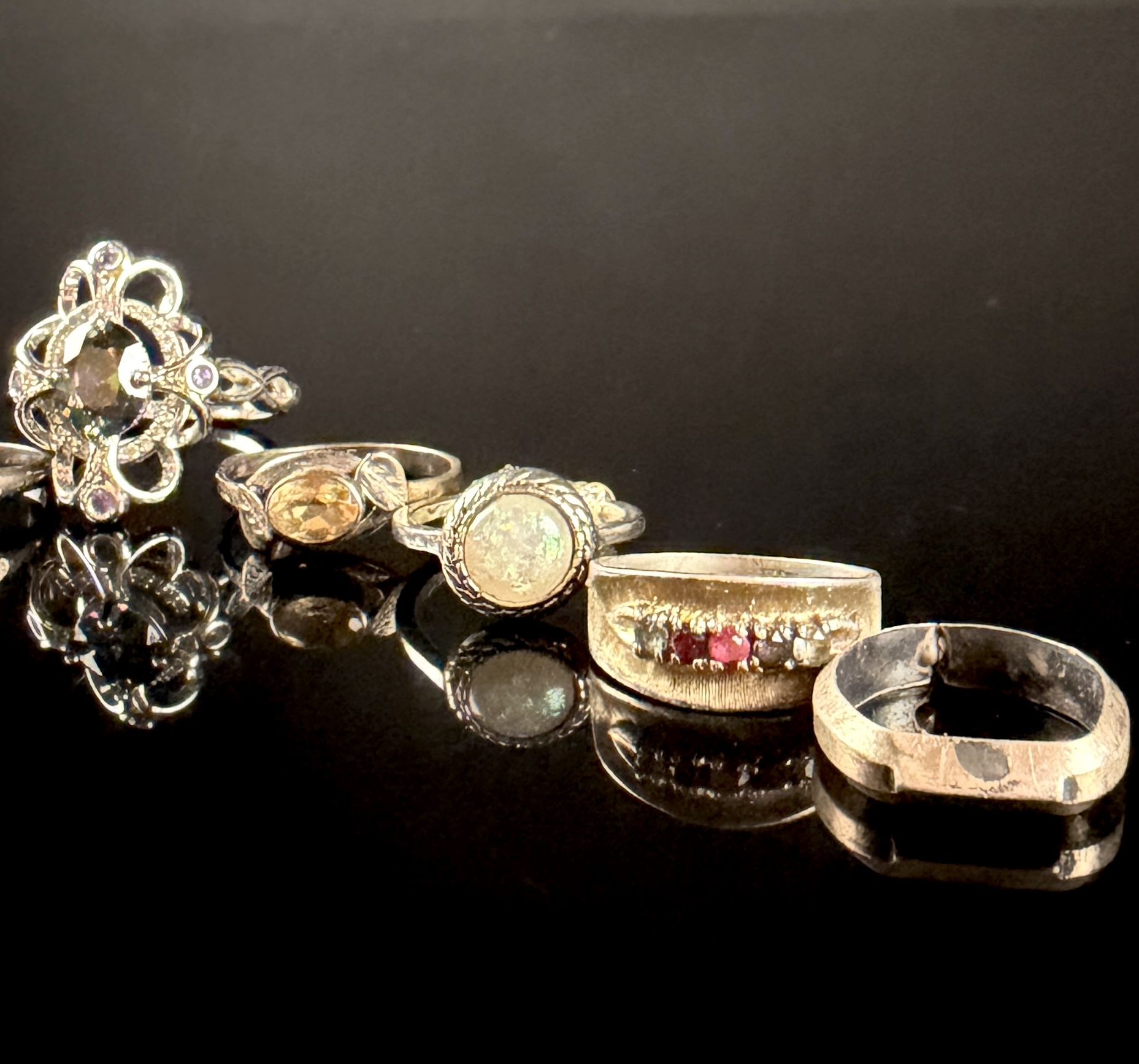 A Collection of Nine Sterling Silver Rings with Various Gemstones and Decorative Accents