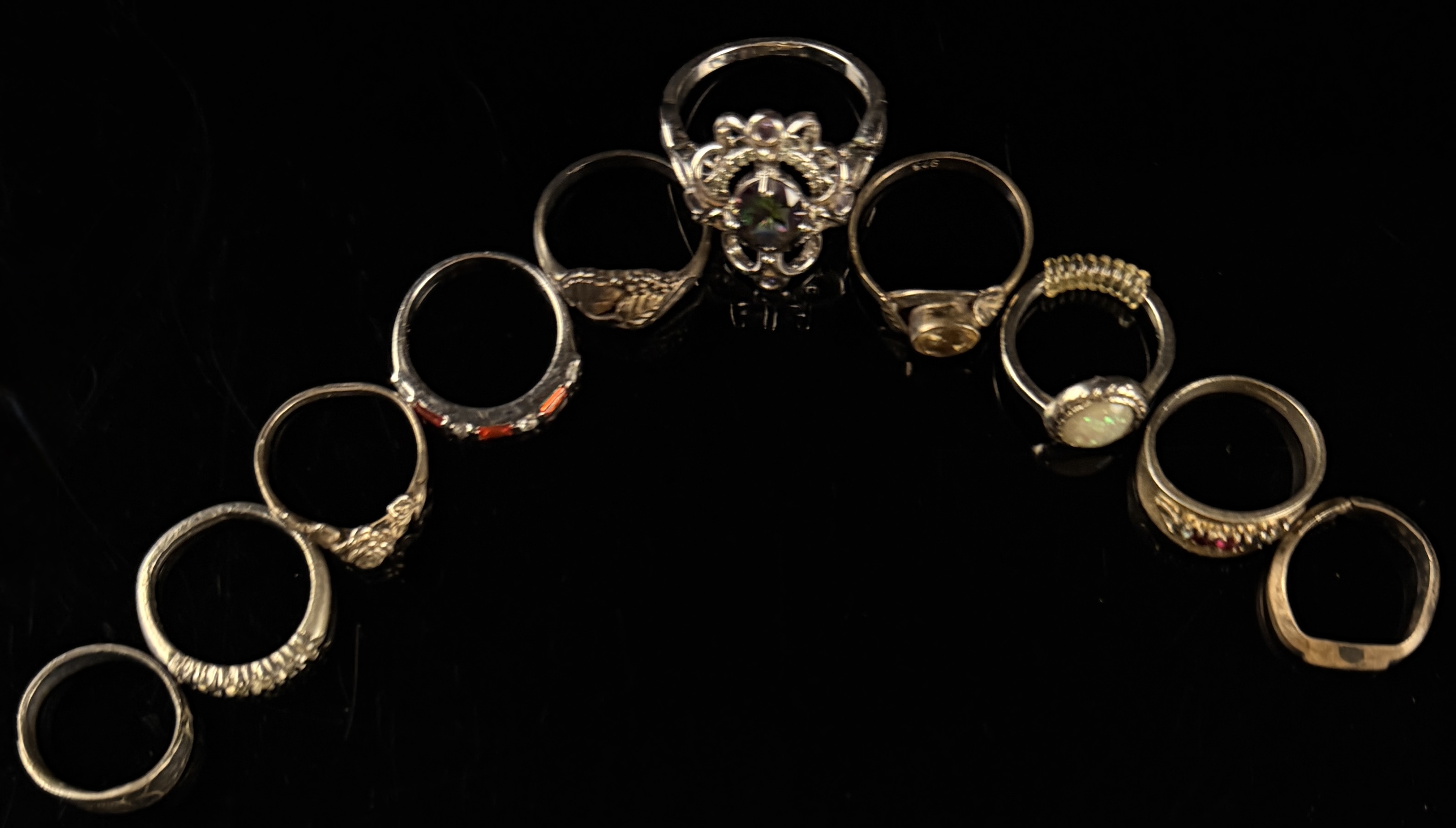 A Collection of Nine Sterling Silver Rings with Various Gemstones and Decorative Accents