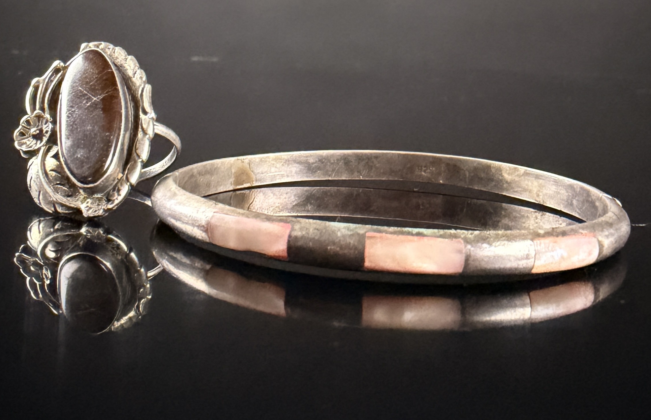 Two Pieces of Navajo Sterling Silver Jewelry Including a Petrified Wood Ring and a Mother-of-Pearl Inlay Bracelet