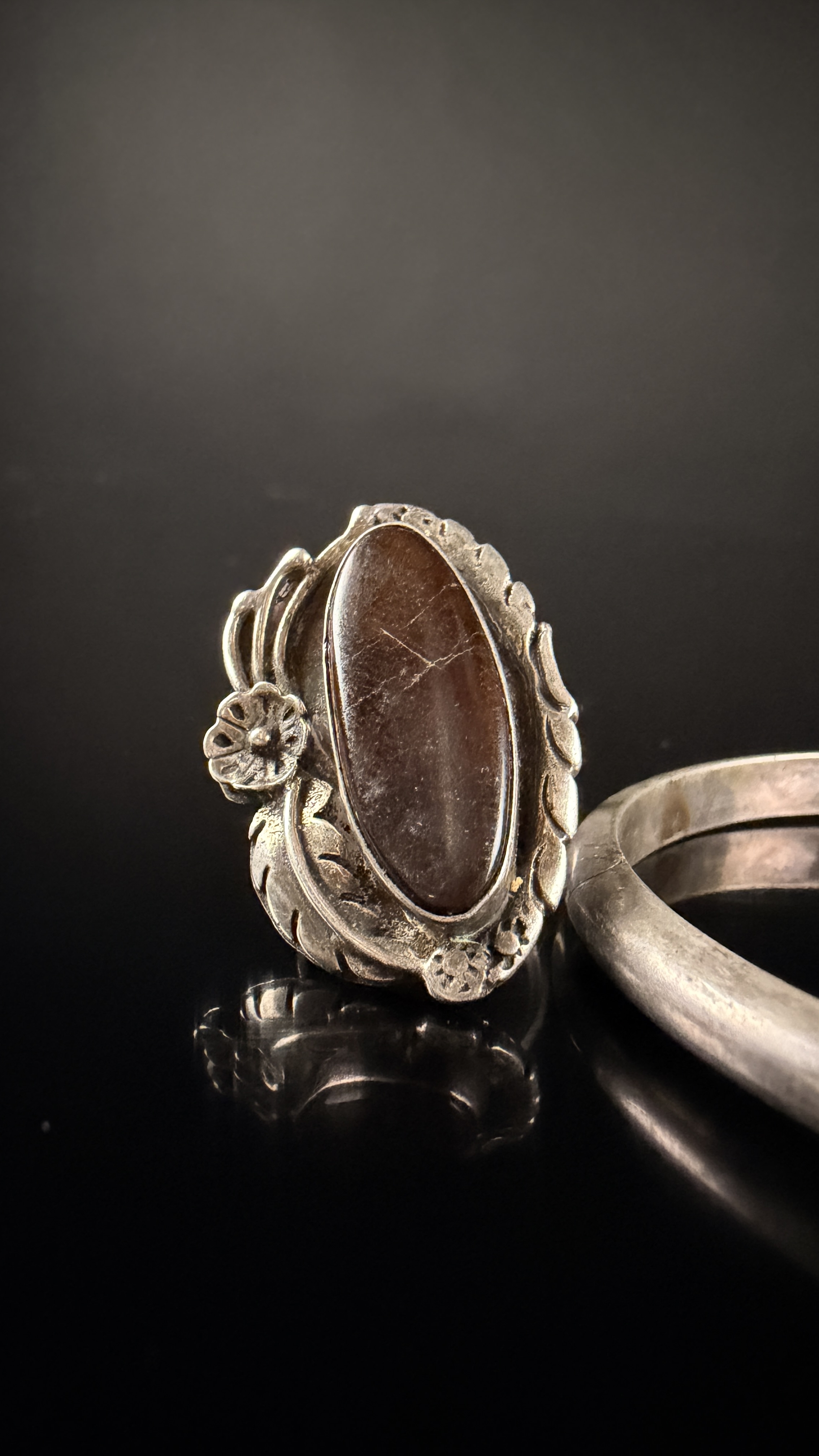 Two Pieces of Navajo Sterling Silver Jewelry Including a Petrified Wood Ring and a Mother-of-Pearl Inlay Bracelet