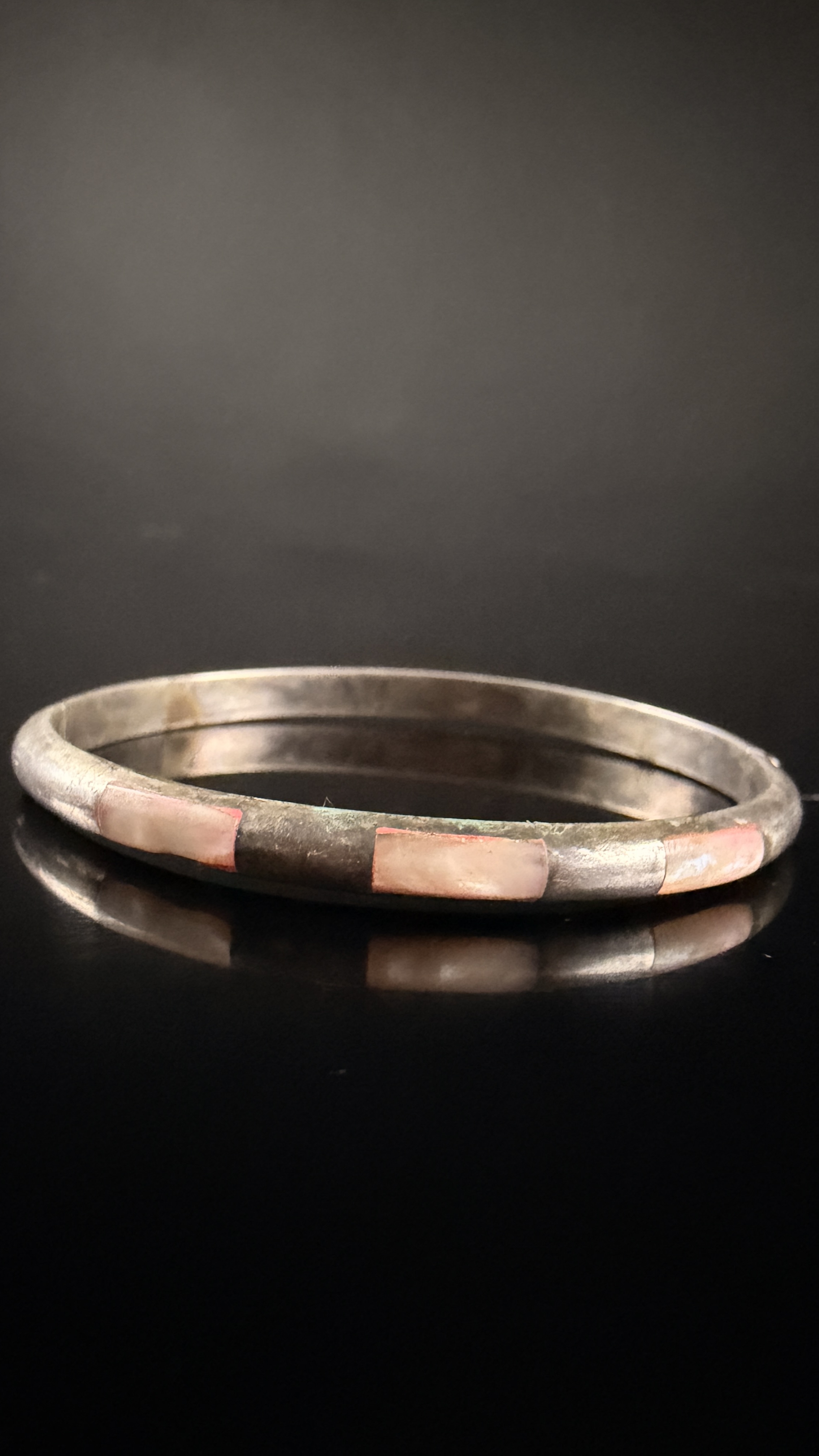 Two Pieces of Navajo Sterling Silver Jewelry Including a Petrified Wood Ring and a Mother-of-Pearl Inlay Bracelet