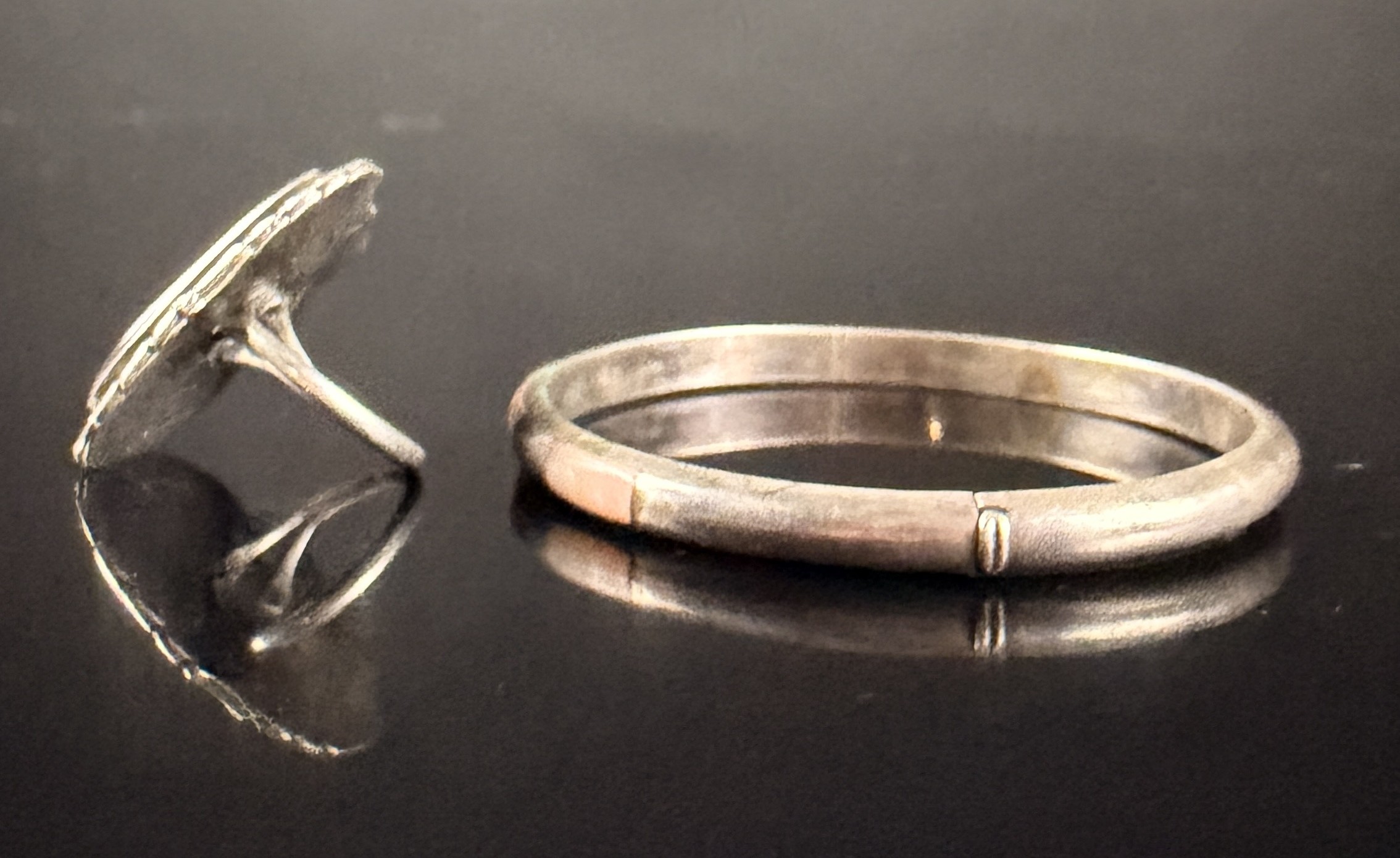 Two Pieces of Navajo Sterling Silver Jewelry Including a Petrified Wood Ring and a Mother-of-Pearl Inlay Bracelet