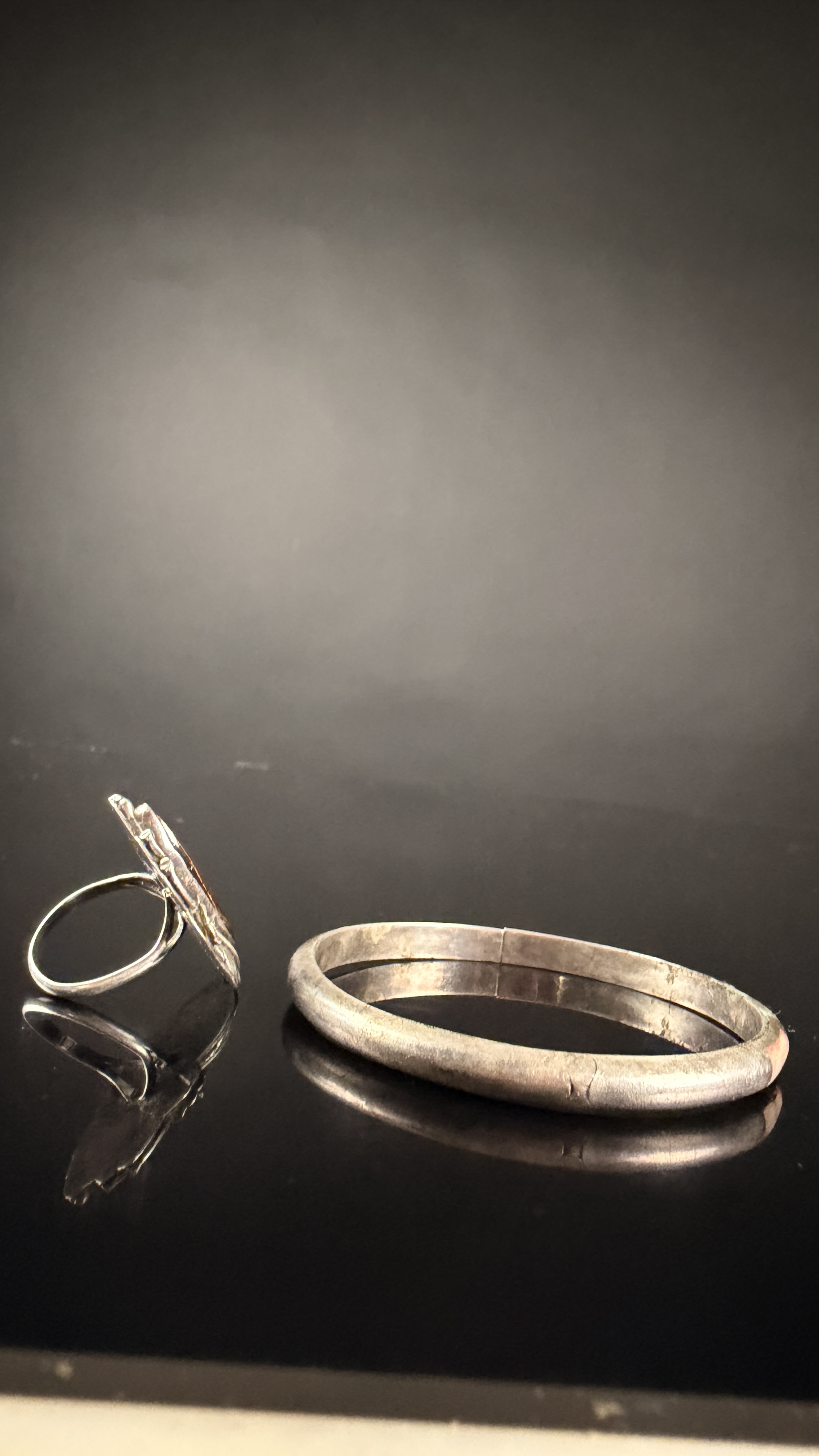 Two Pieces of Navajo Sterling Silver Jewelry Including a Petrified Wood Ring and a Mother-of-Pearl Inlay Bracelet