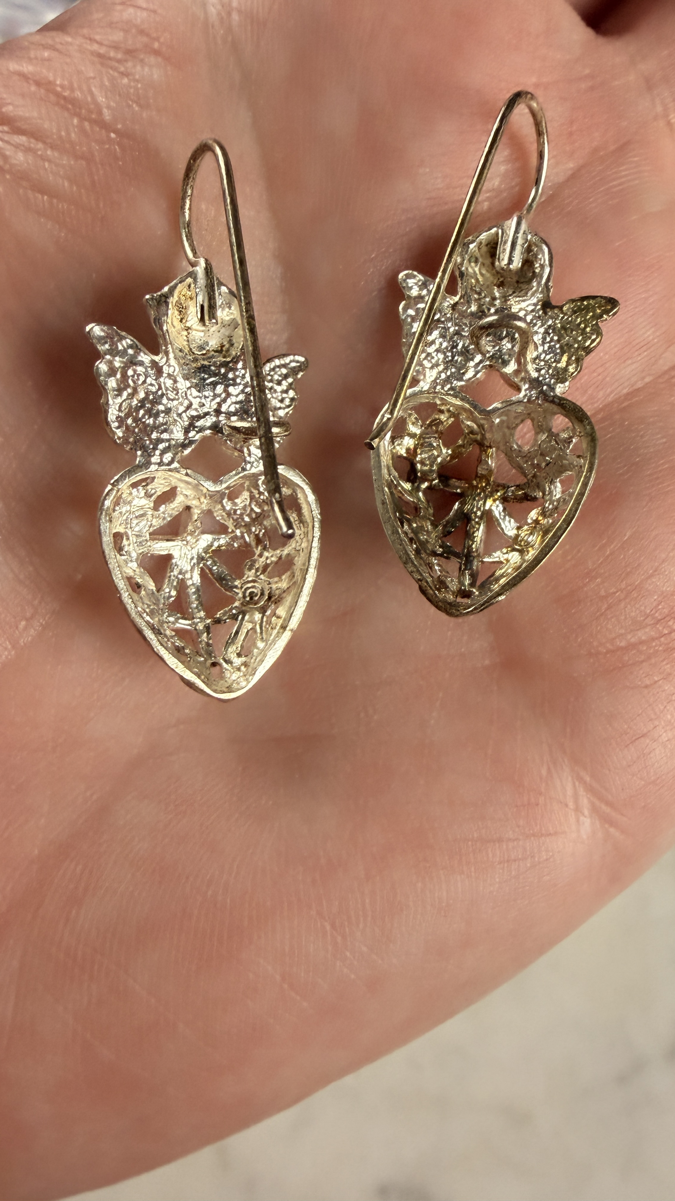 A Pair of Sterling Silver Cherub and Filigree Heart Drop Earrings