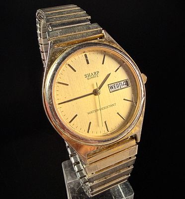 Sharp Quartz Day-Date Dress Watch with Two-Tone Expansion Bracelet. A vintage Sharp analog dress 