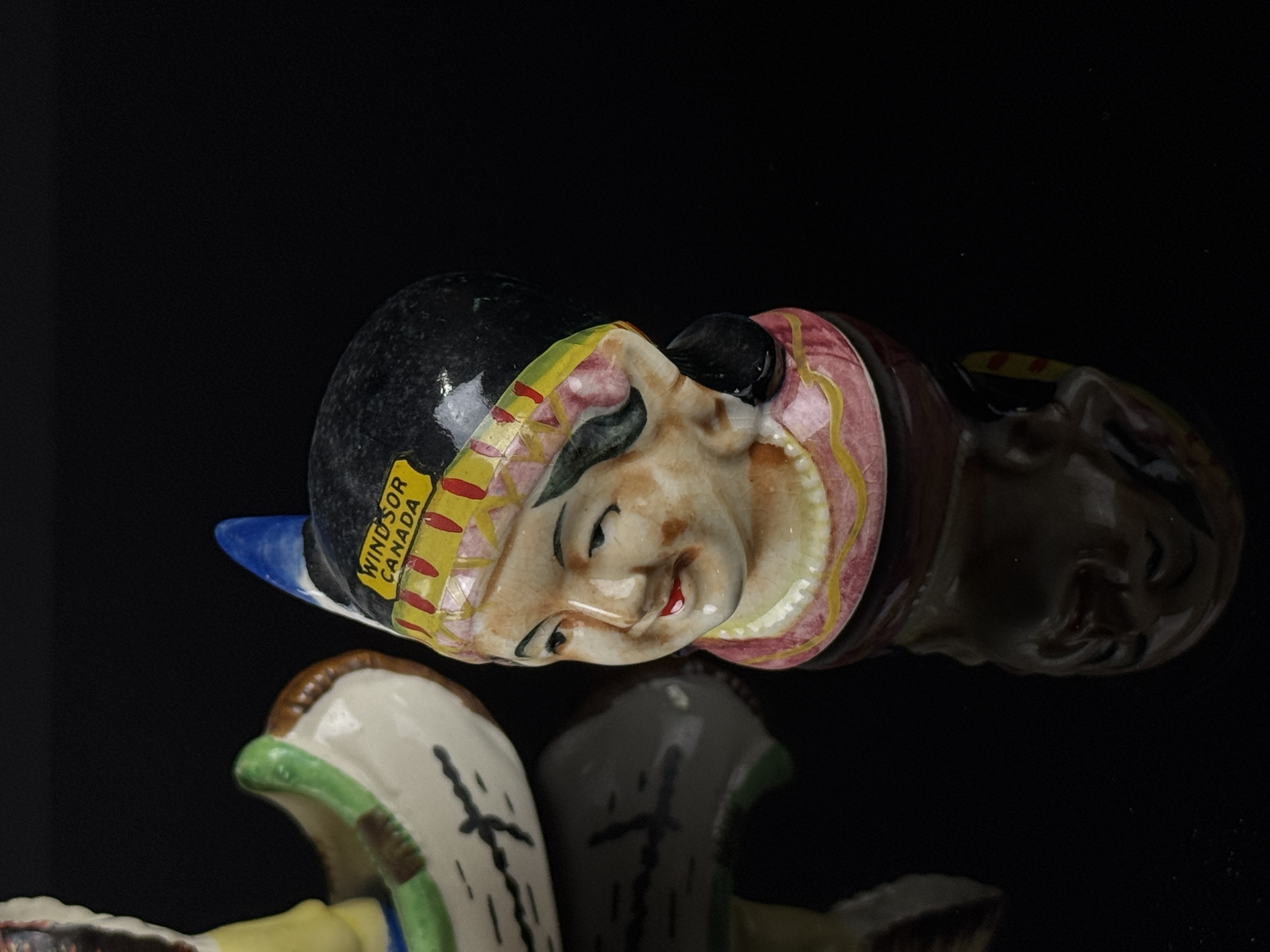 A Set of Four Japanese Hand Painted Ceramic Native American Souvenir Salt and Pepper Shakers and Canoe Base