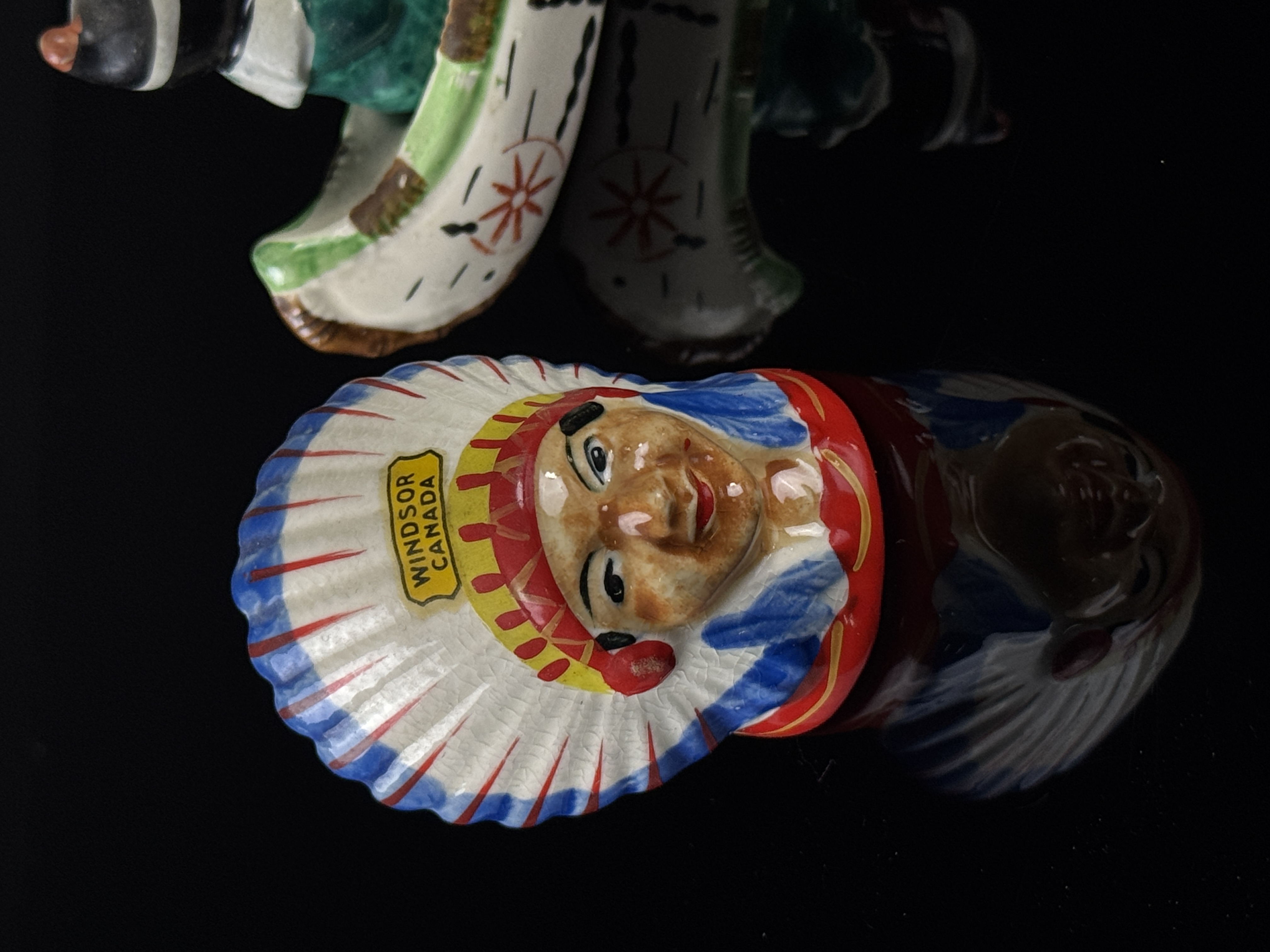 A Set of Four Japanese Hand Painted Ceramic Native American Souvenir Salt and Pepper Shakers and Canoe Base