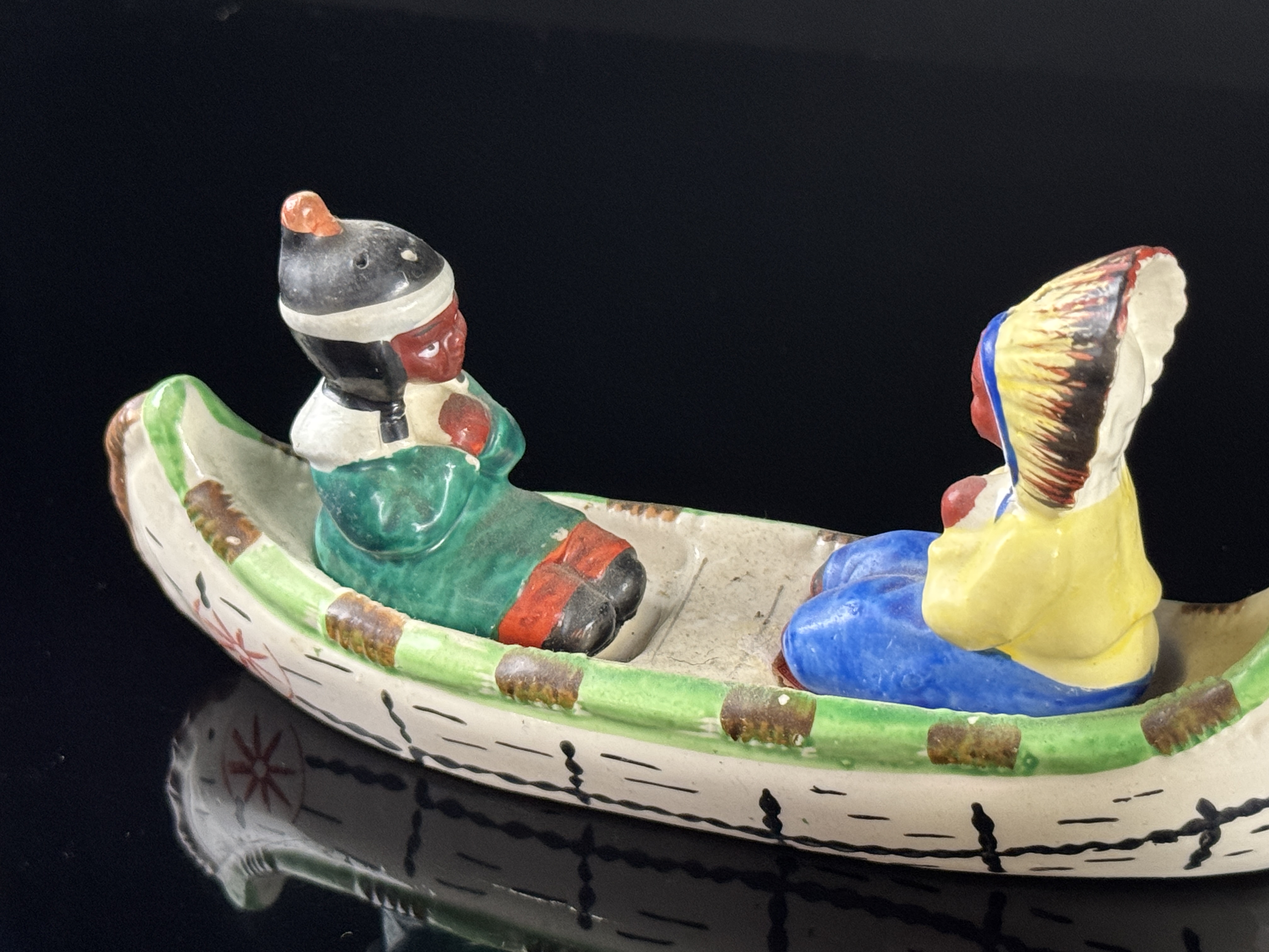 A Set of Four Japanese Hand Painted Ceramic Native American Souvenir Salt and Pepper Shakers and Canoe Base