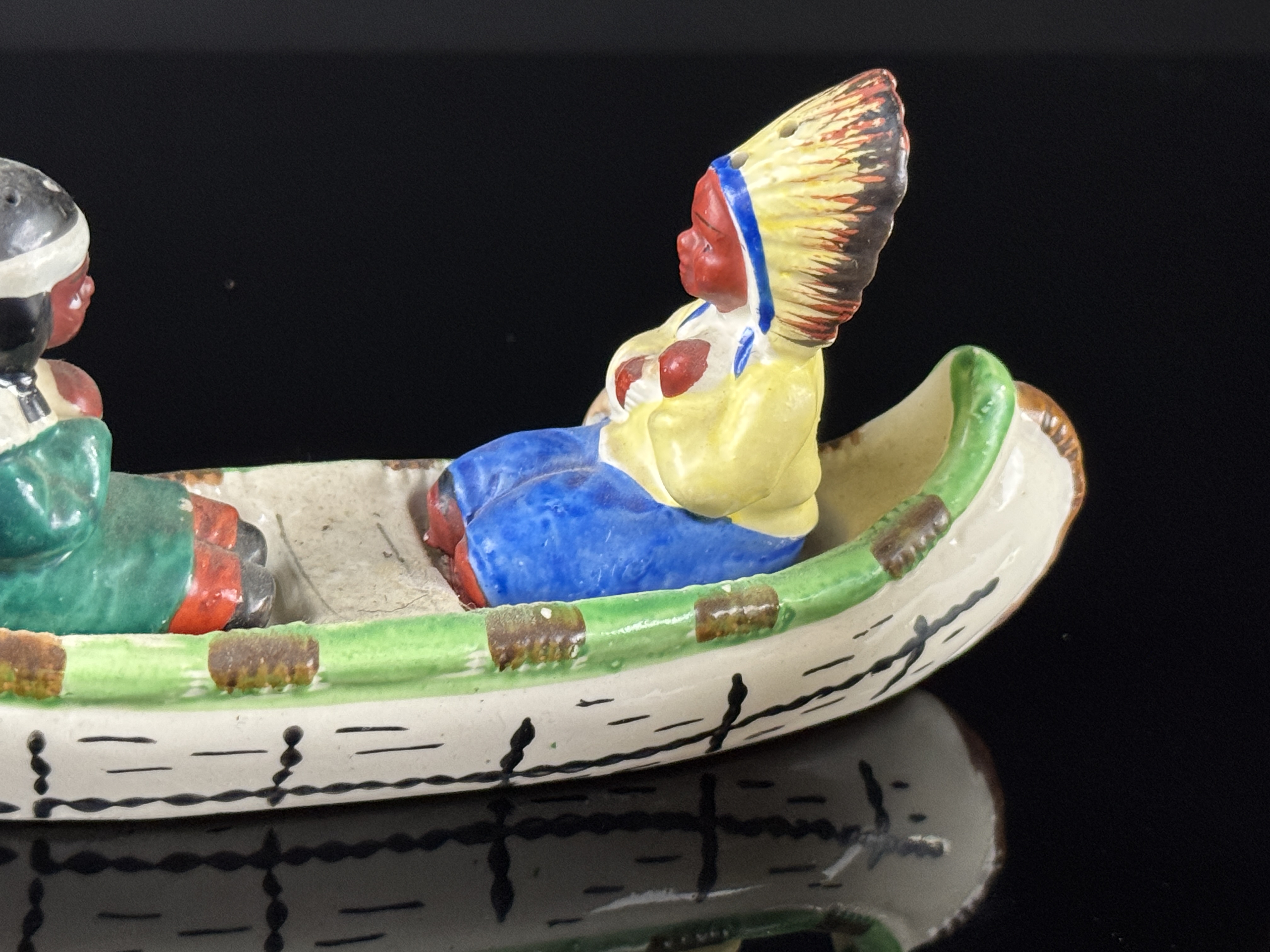 A Set of Four Japanese Hand Painted Ceramic Native American Souvenir Salt and Pepper Shakers and Canoe Base