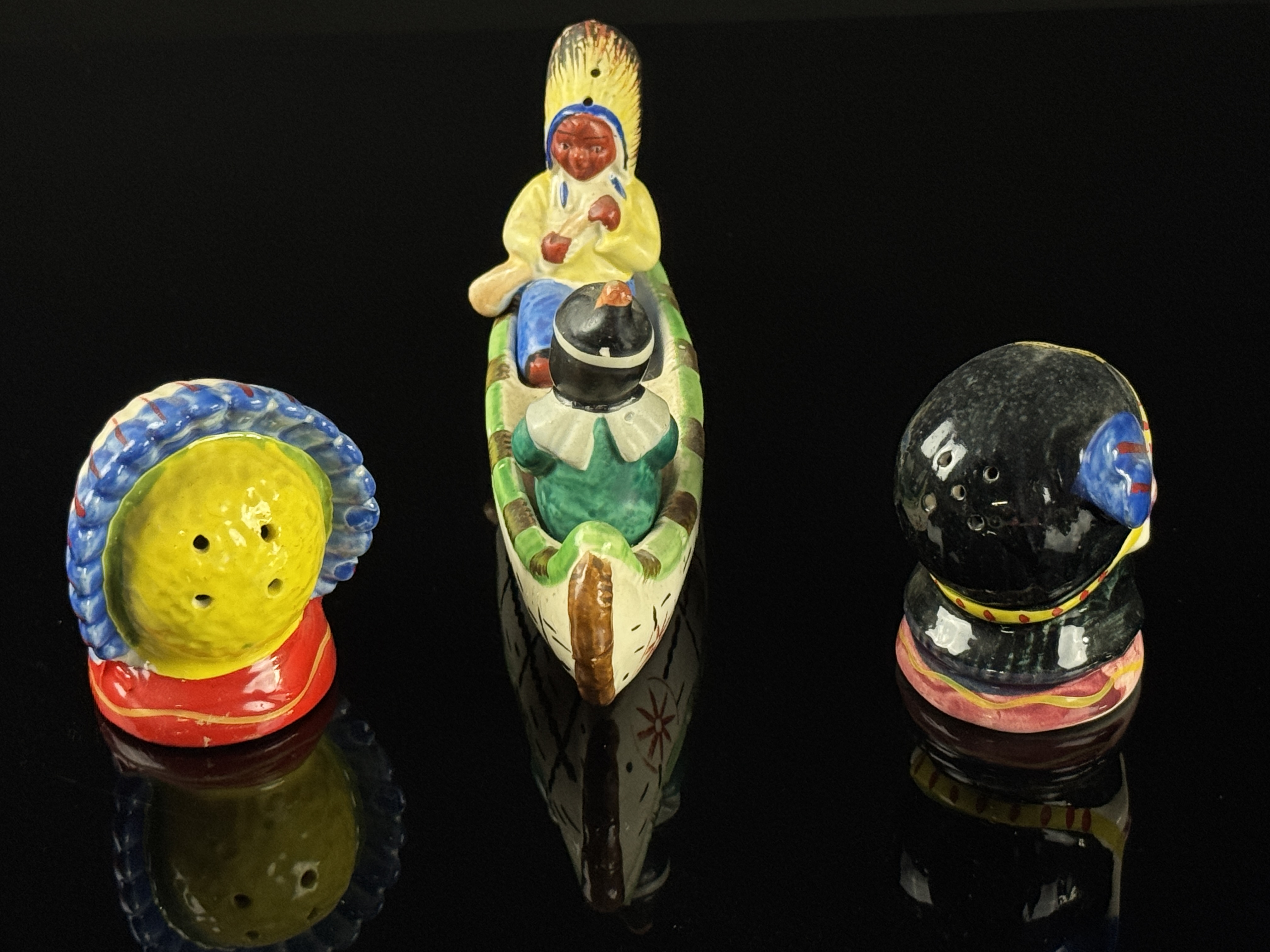 A Set of Four Japanese Hand Painted Ceramic Native American Souvenir Salt and Pepper Shakers and Canoe Base
