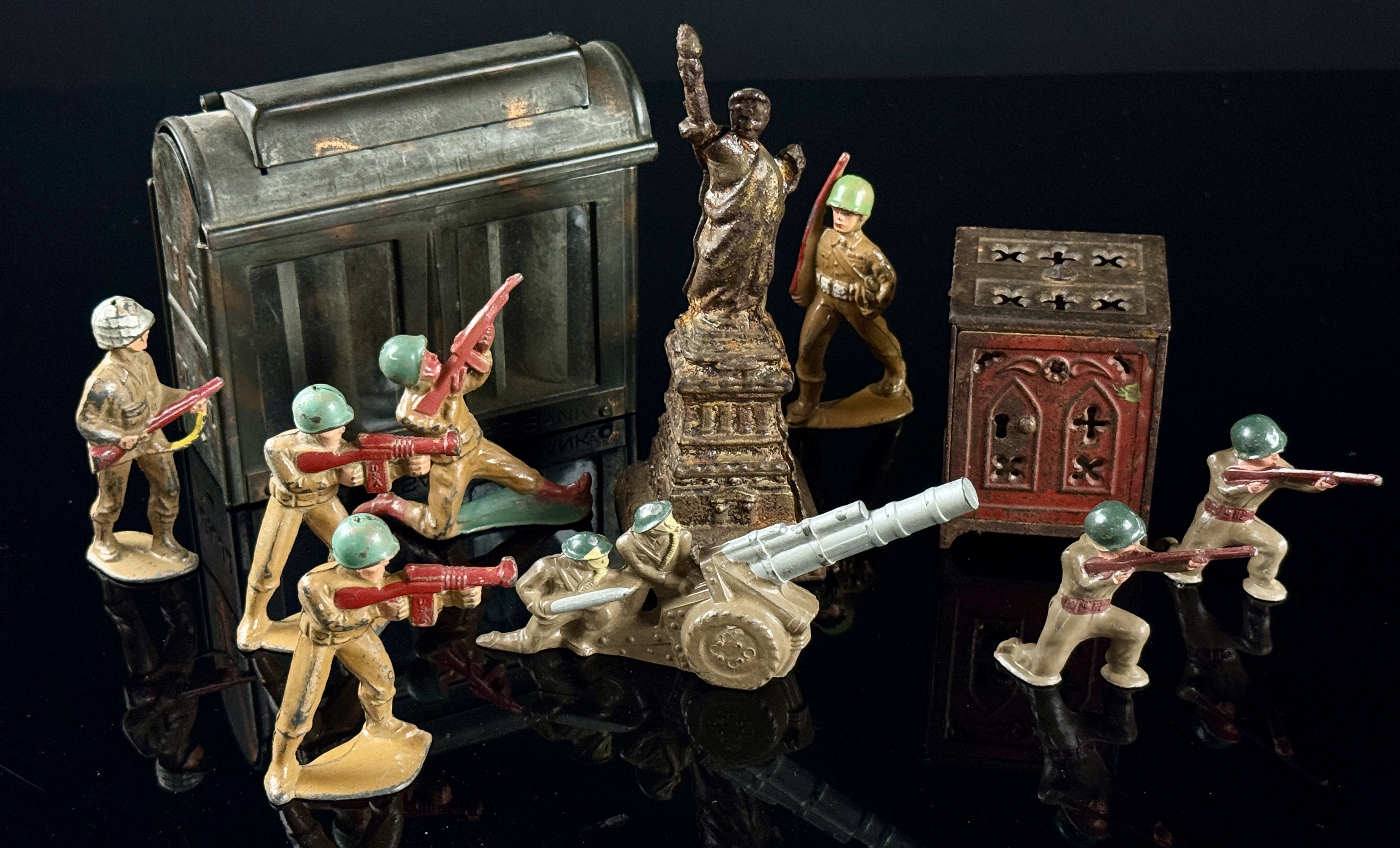 A Collection of Vintage Cast Metal Savings Banks and Military Figures
