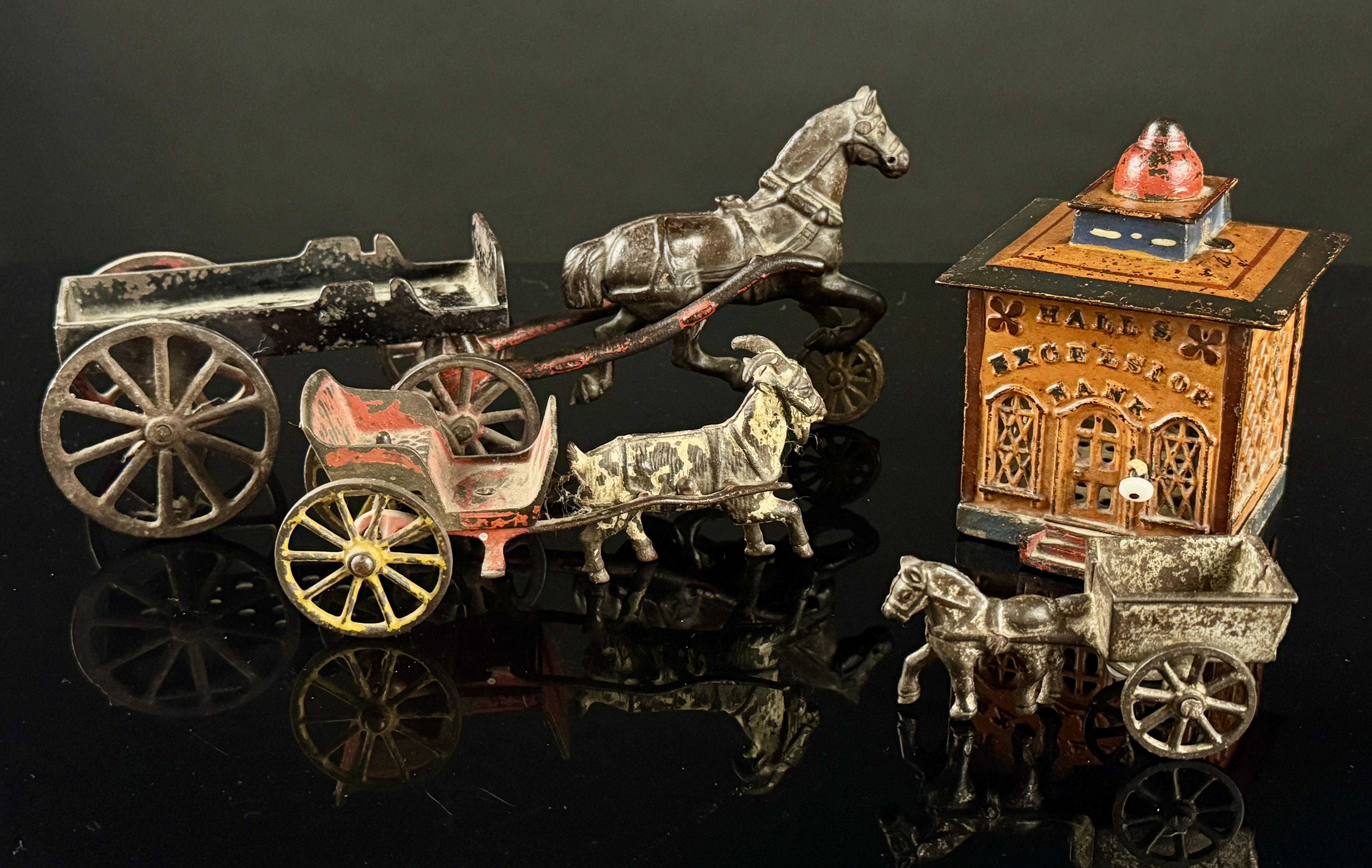 A Collection of Antique Cast Iron Animal-Drawn Toys and a Hall's Excelsior Mechanical Bank