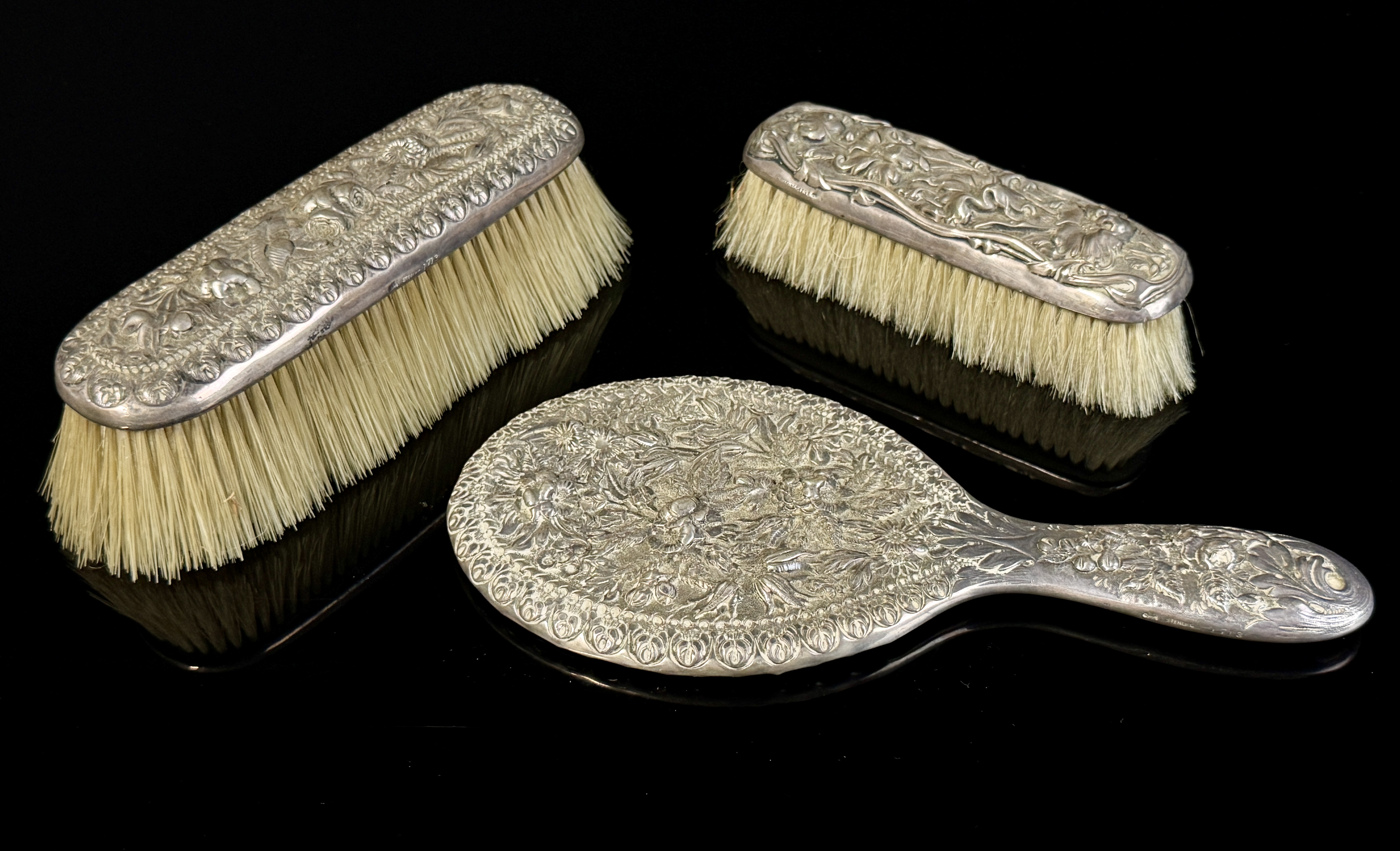A Three-Piece Gorham Manufacturing Company Sterling Silver Floral Repousse Vanity Dresser Set