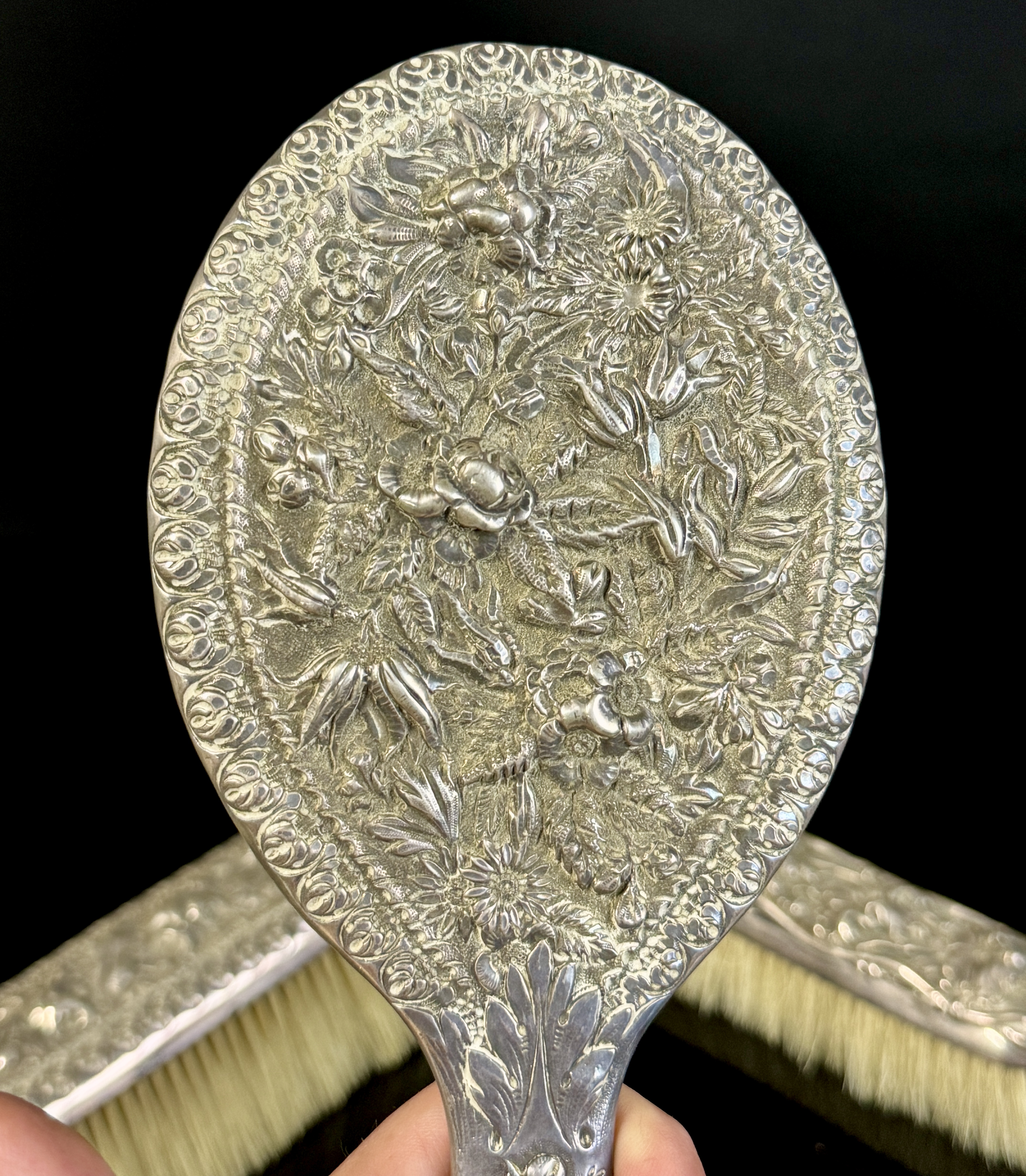 A Three-Piece Gorham Manufacturing Company Sterling Silver Floral Repousse Vanity Dresser Set