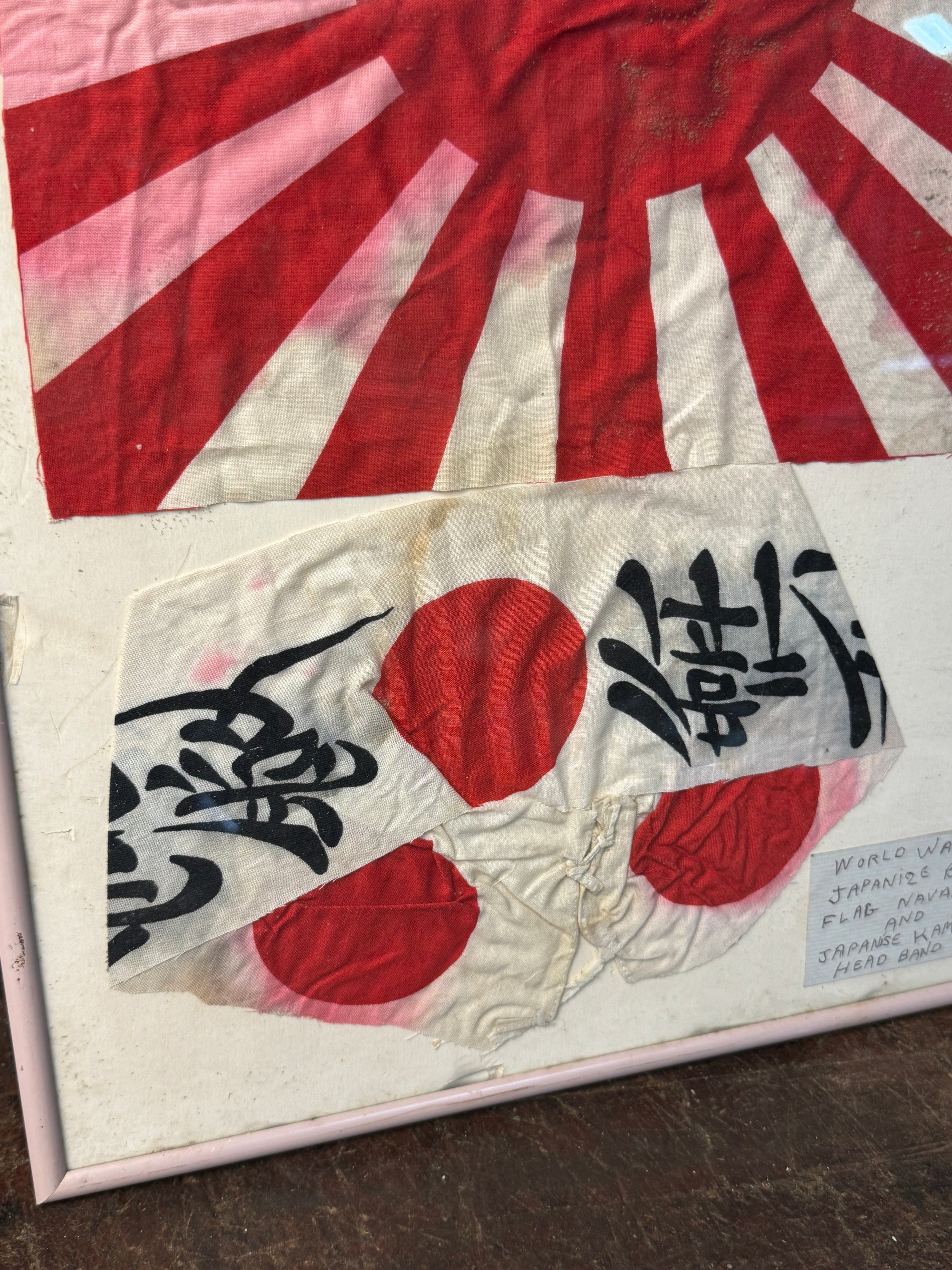 Two Framed World War II Imperial Japanese Textiles Including a Rising Sun War Flag and Kamikaze Hachimaki
