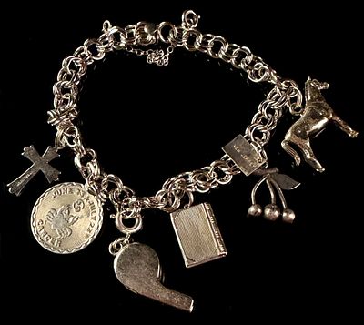 A Sterling Silver Double-Link Charm Bracelet with Multiple Charms. This sterling silver bracelet 