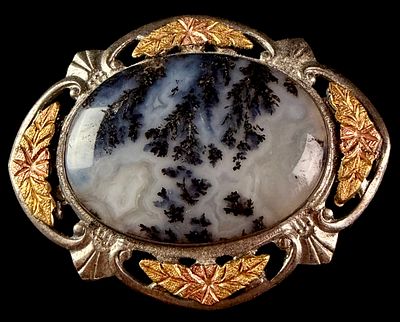 Sterling Silver and Tricolor Gold Dendritic Agate Brooch. An oval sterling silver brooch 