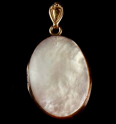 Twelve Karat Gold-Filled and Mother-of-Pearl Oval Locket Pendant. This oval locket pendant is 