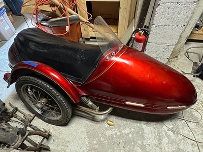 Vintage Velorex Sidecar With Fiberglass Body and Spoked Wheel. This vintage motorcycle sidecar 