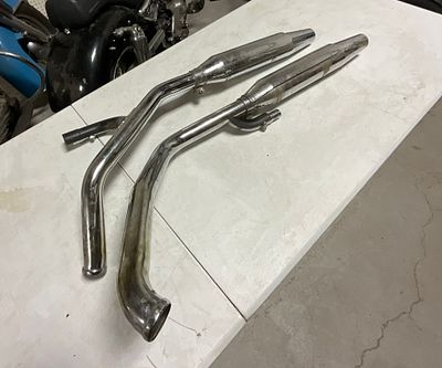 A Pair of Harley-Davidson OEM Chrome Exhaust Head Pipes and Mufflers Part Number 55344-99. This 