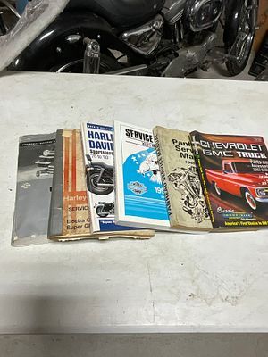 A Collection of Harley-Davidson Service Manuals and a Chevrolet GMC Truck Parts Catalog. An 