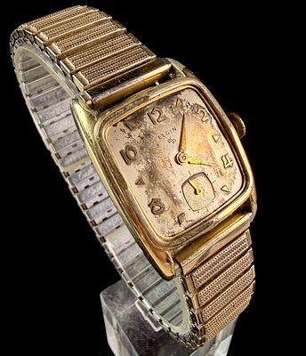 Elgin 10K Rolled Gold Plate Bezel Mechanical Wristwatch with Expansion Band. This mechanical 