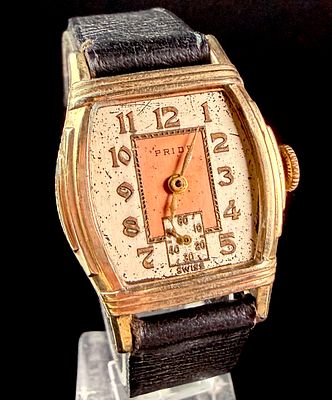 Vintage Pride Manual Wind Two Tone Salmon Dial Tonneau Wristwatch. A Swiss-made manual wind 