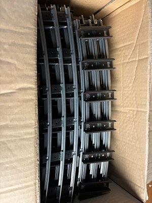 A Collection of Three Rail O Gauge Curved Model Train Track Sections. An assortment of curved 