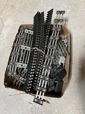 A Collection of Lionel and Assorted O Gauge Model Train Track and Power Adapters. This 