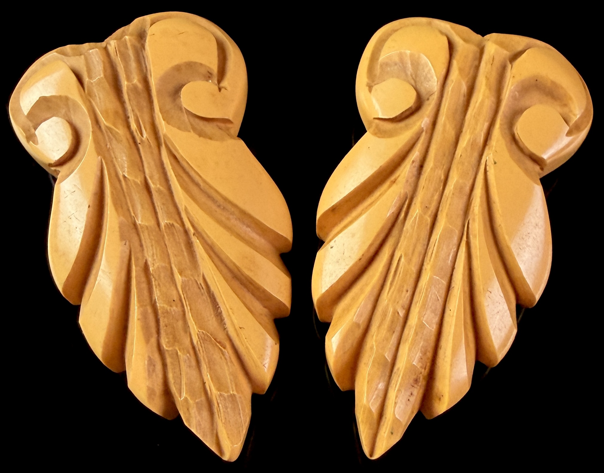 A Pair of Art Deco Deeply Carved Butterscotch Bakelite Dress Clips