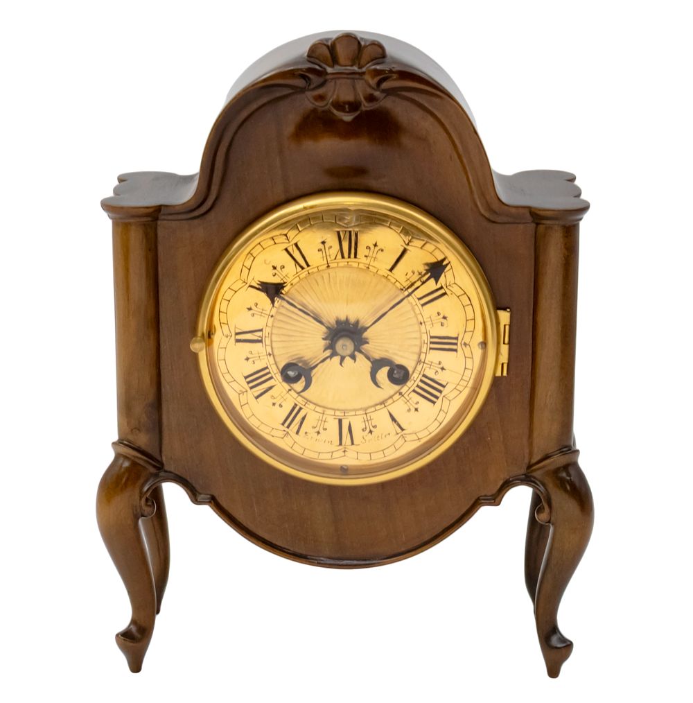 Erwin Sattler Table Mantel Clock. 
Beautifully carved wooden frame. 
Mechanical movement 
