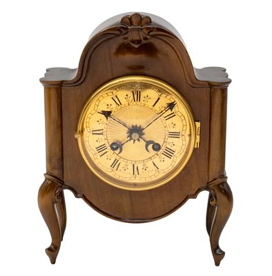 Erwin Sattler Table Mantel Clock. 
Beautifully carved wooden frame. 
Mechanical movement 