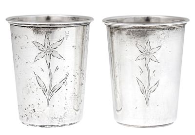 Pair of Silver Cups. 
Floral engravings. 
Marked (835). 
Height: 6.5cm. 