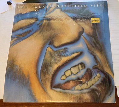 🎶 Joe Cocker – Sheffield Steel הוצאה: Island Records. שנה: 1982. מדינה: איטליה. הוצאה איטלקית 