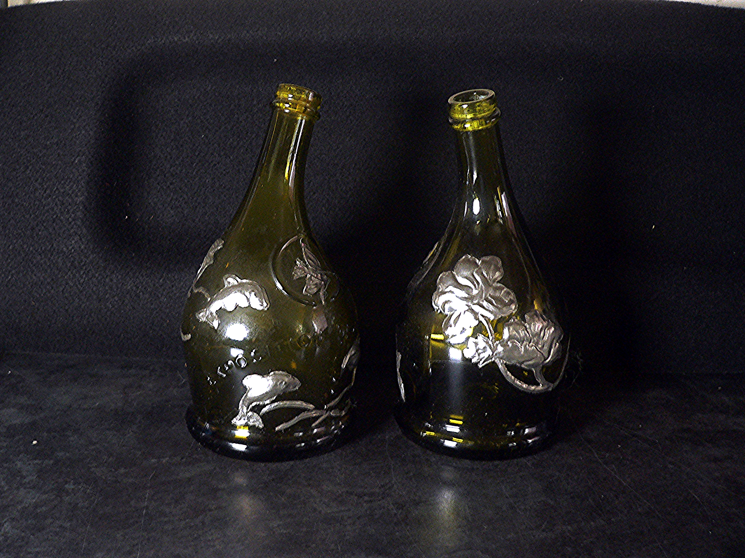 Pair of empty Exposition Universelle decorative embossed bottles
