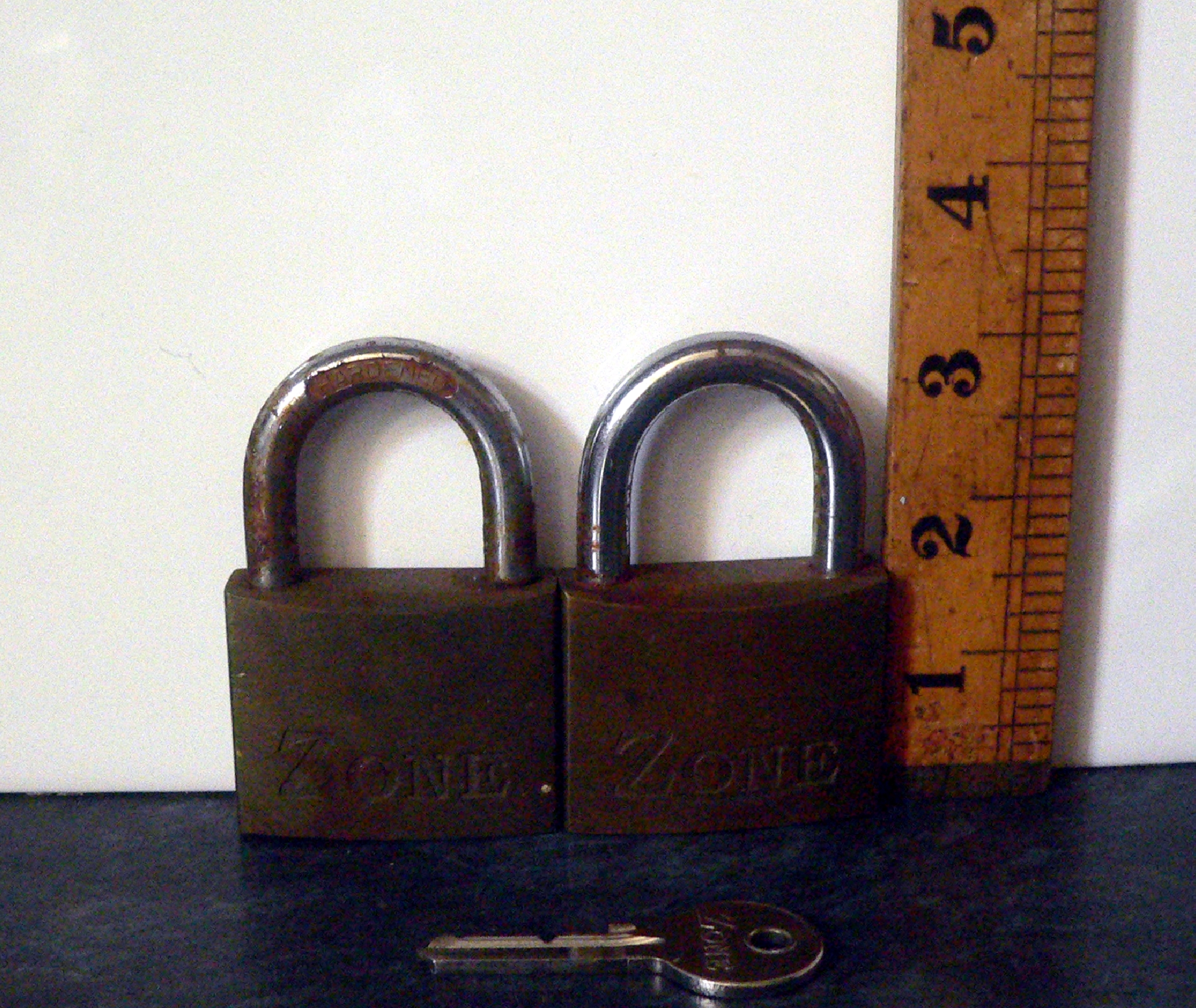 Pair of Zone brass heavy duty padlocks with one key that opens both
