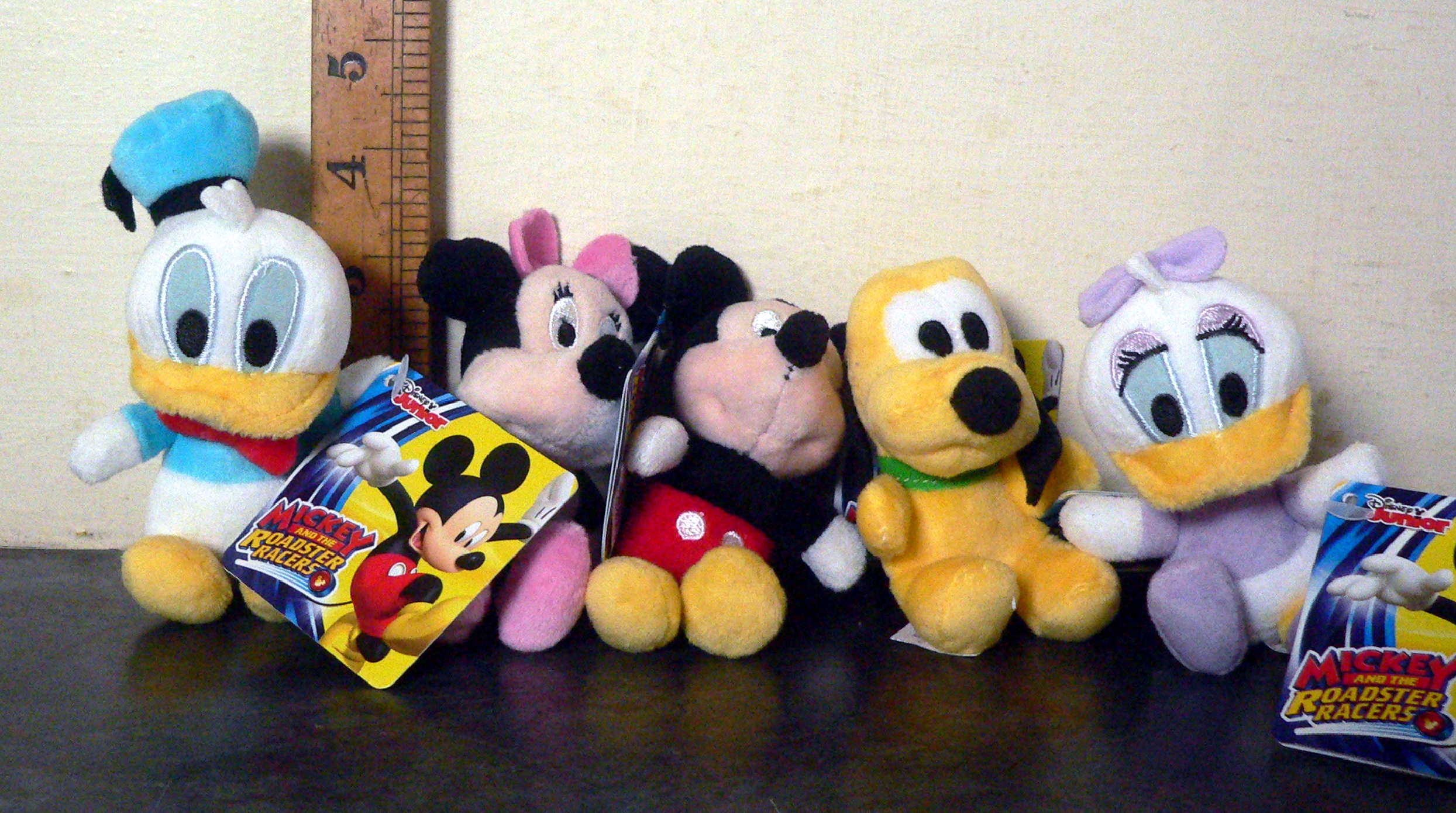 Five Disney mini plush toys with tags