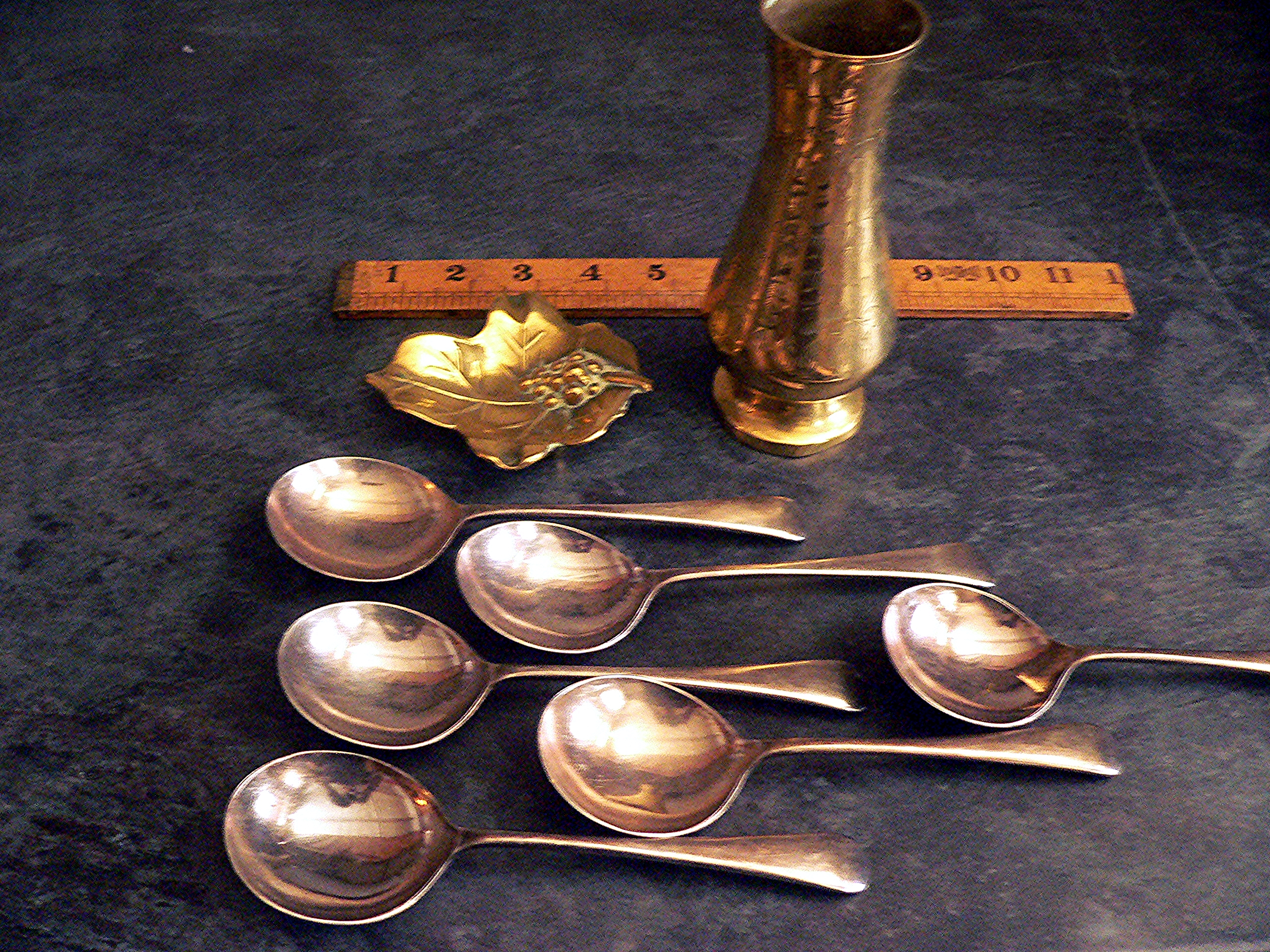 Heavy silver plated spoons, a brass leaf trinket dish and a brass vase