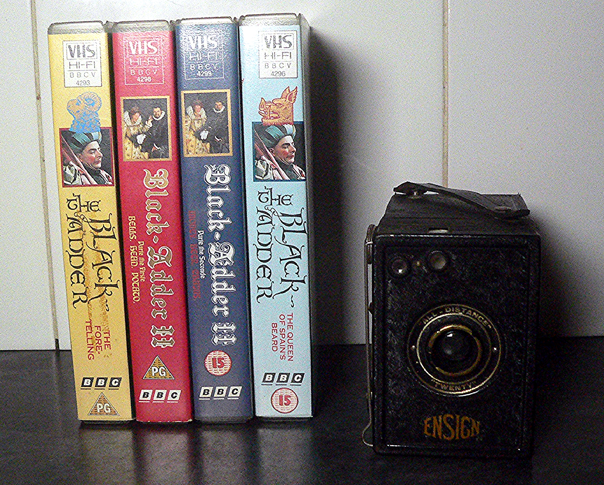Four Blackadder VHS videos and an antique Ensign box camera